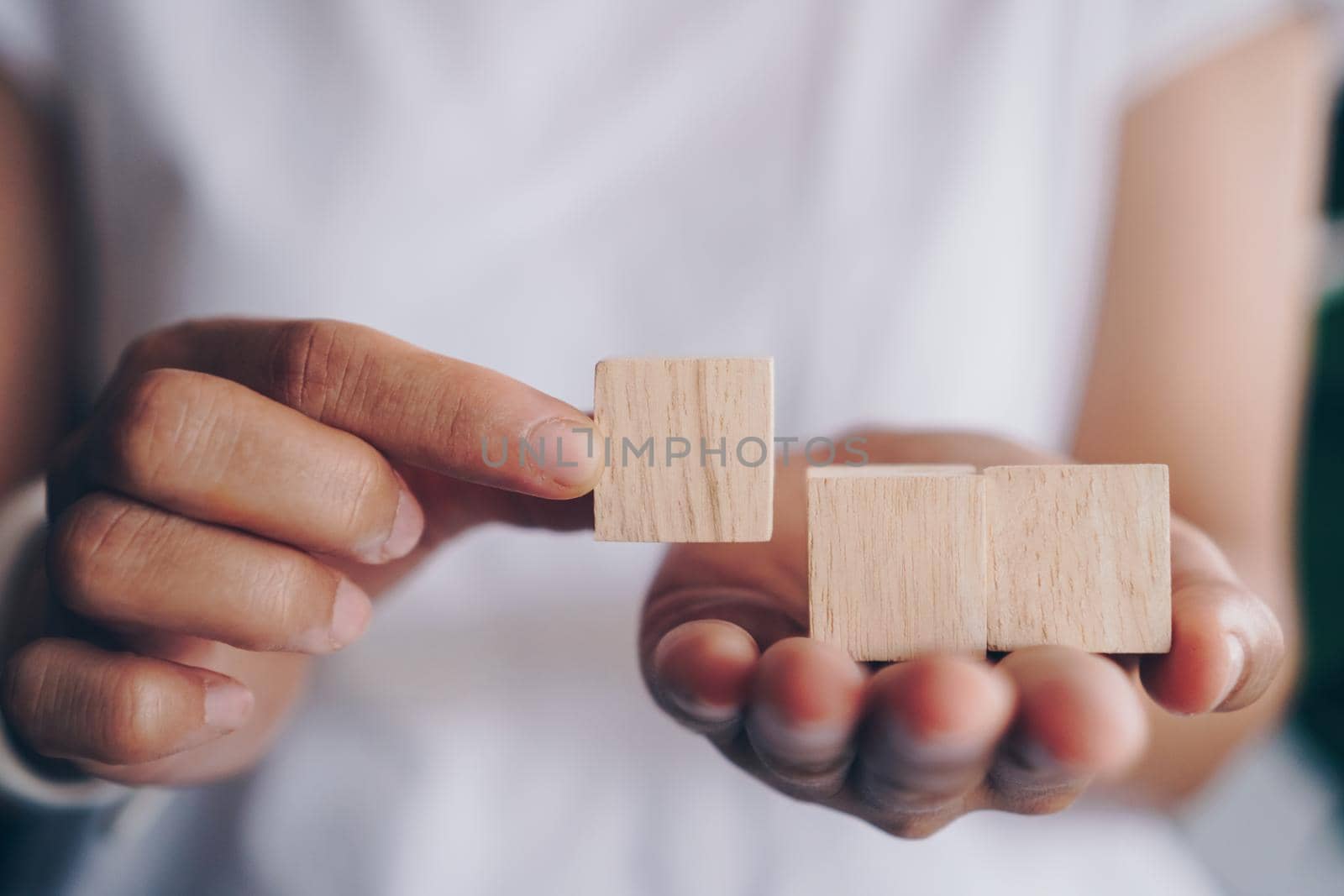 Blank wooden cube that you can put text or icon on in hand hold by Suwant