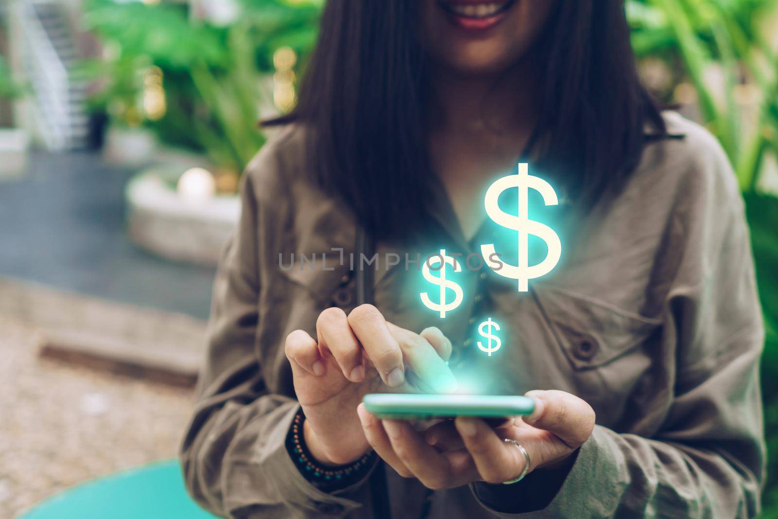 Woman use gadget mobile smartphone earn money online with dollar icon pop up. Business fintech technology on smartphone concept.