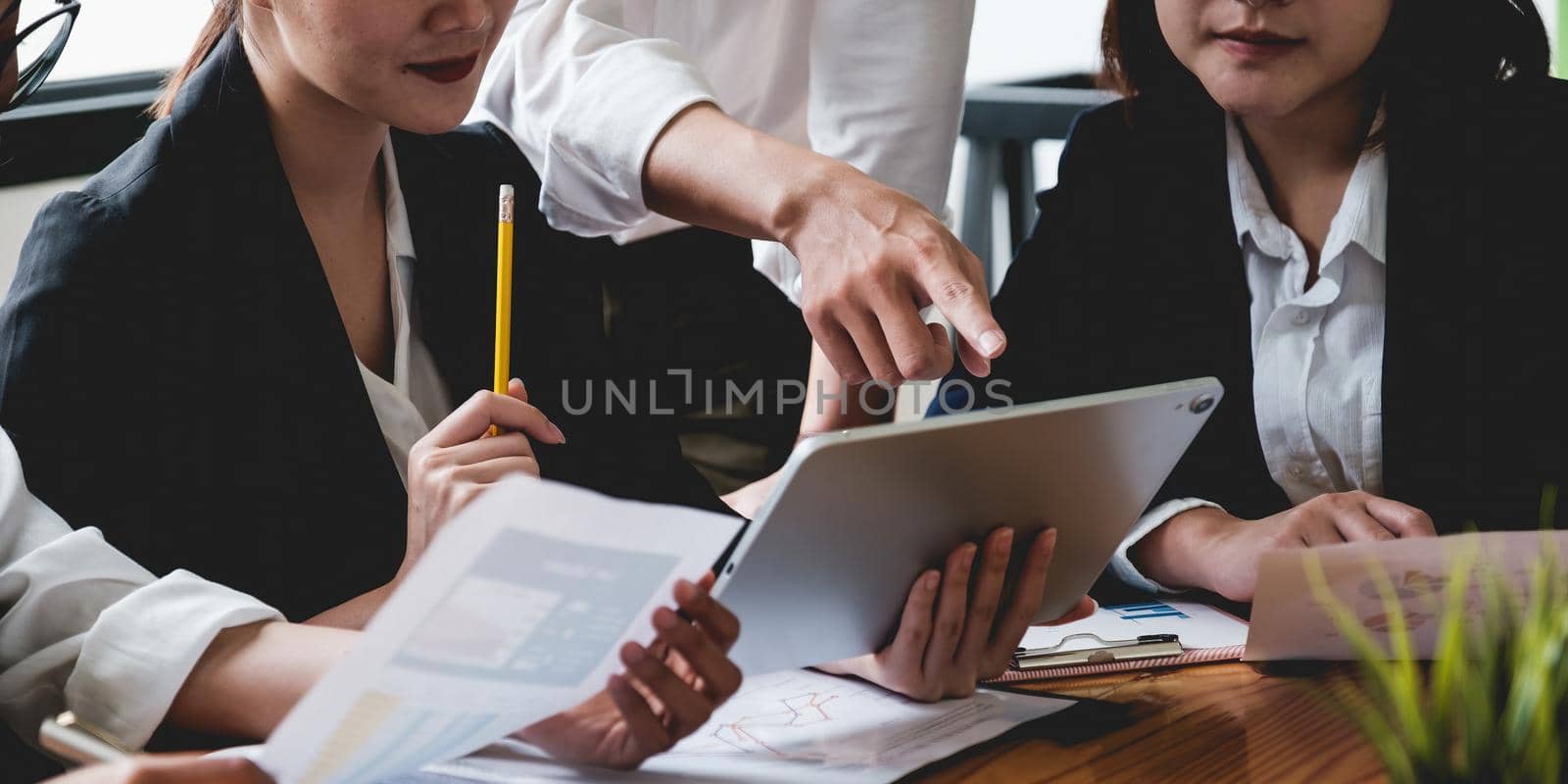 Group of Businesswoman and Accountant checking data document on digital tablet for investigation of corruption account . Anti Bribery concept. by itchaznong