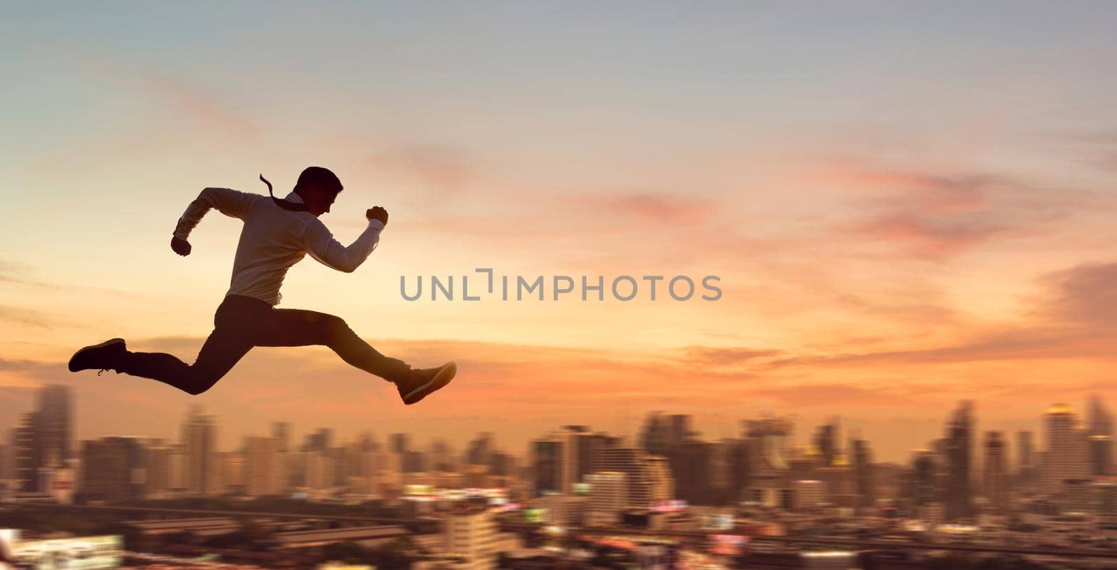 Young businessman jumping high, Work, job, or successful business concept. Cityscape background.