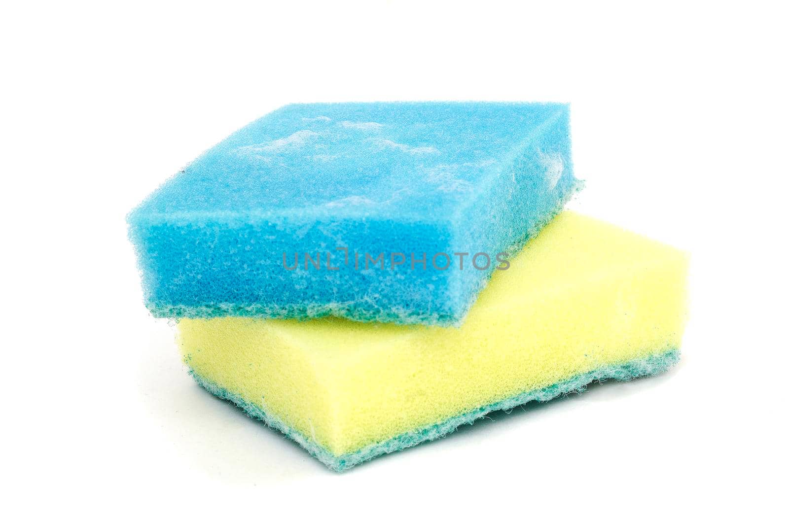 a blue and a yellow sponge isolated on white background. by andre_dechapelle