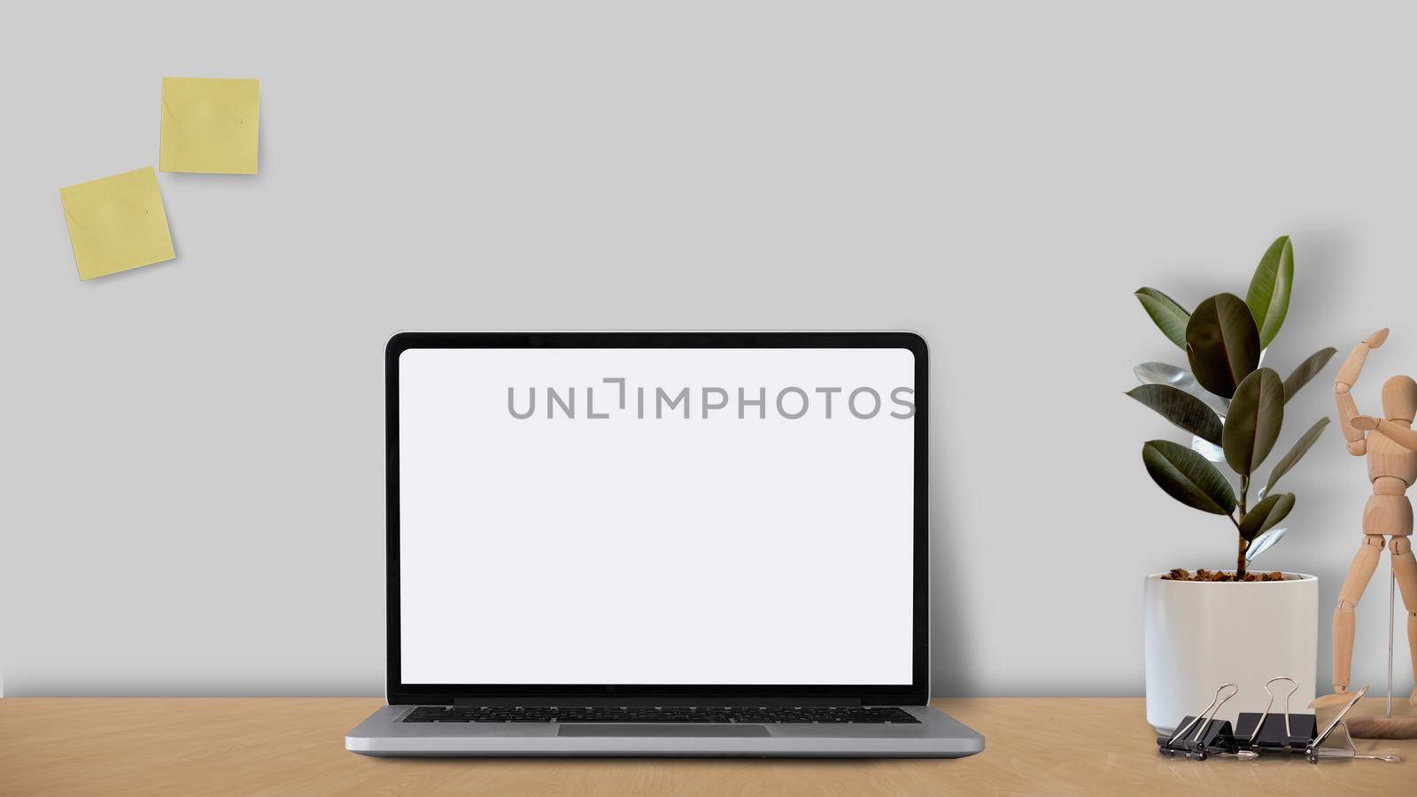 Mock up laptop computer with blank white screen on wooden desk with designer style concept. by nateemee