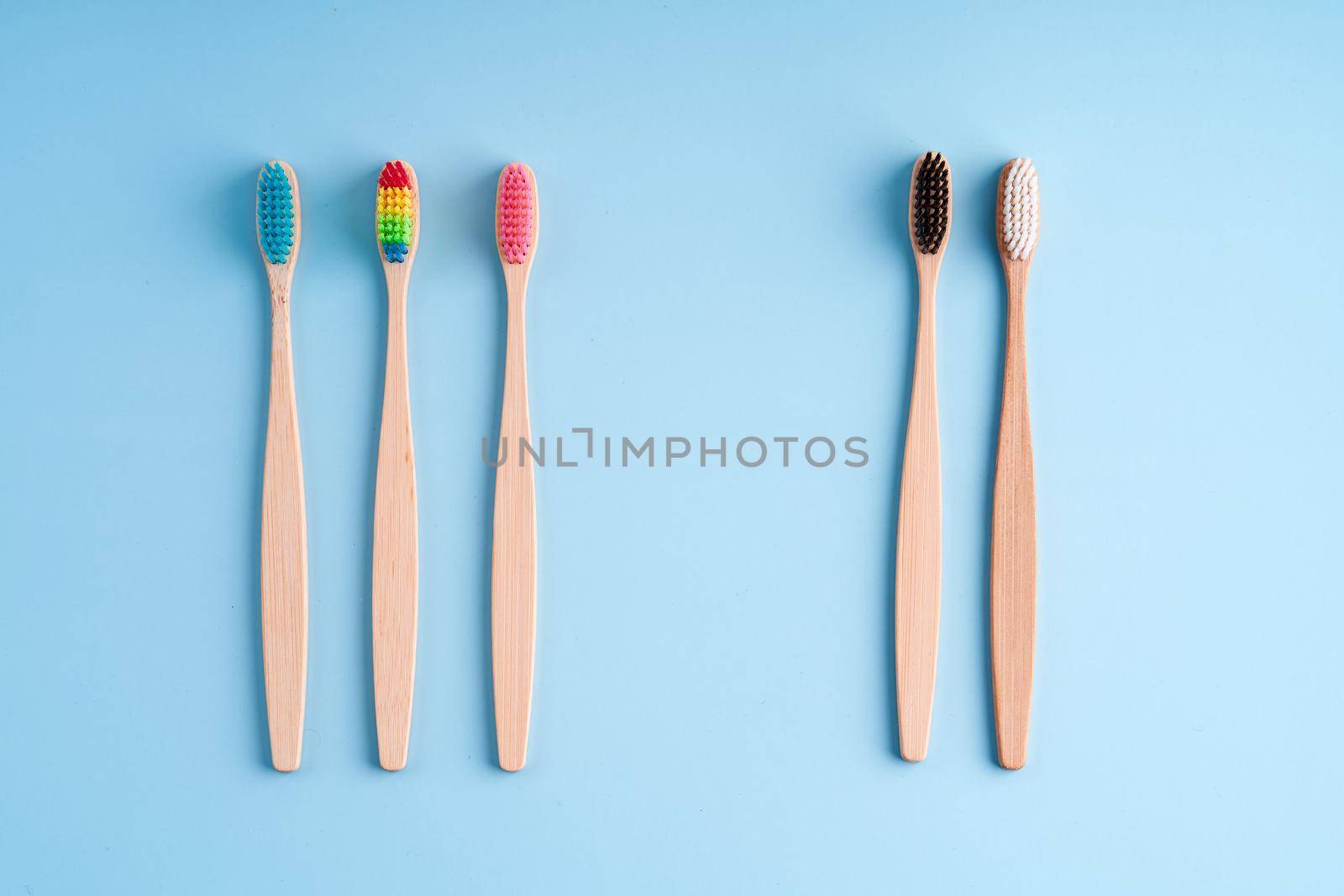 A bunch of eco-friendly bamboo toothbrushes. Global environmental trends. Gender and racial inequality. toothbrushes of different genders.