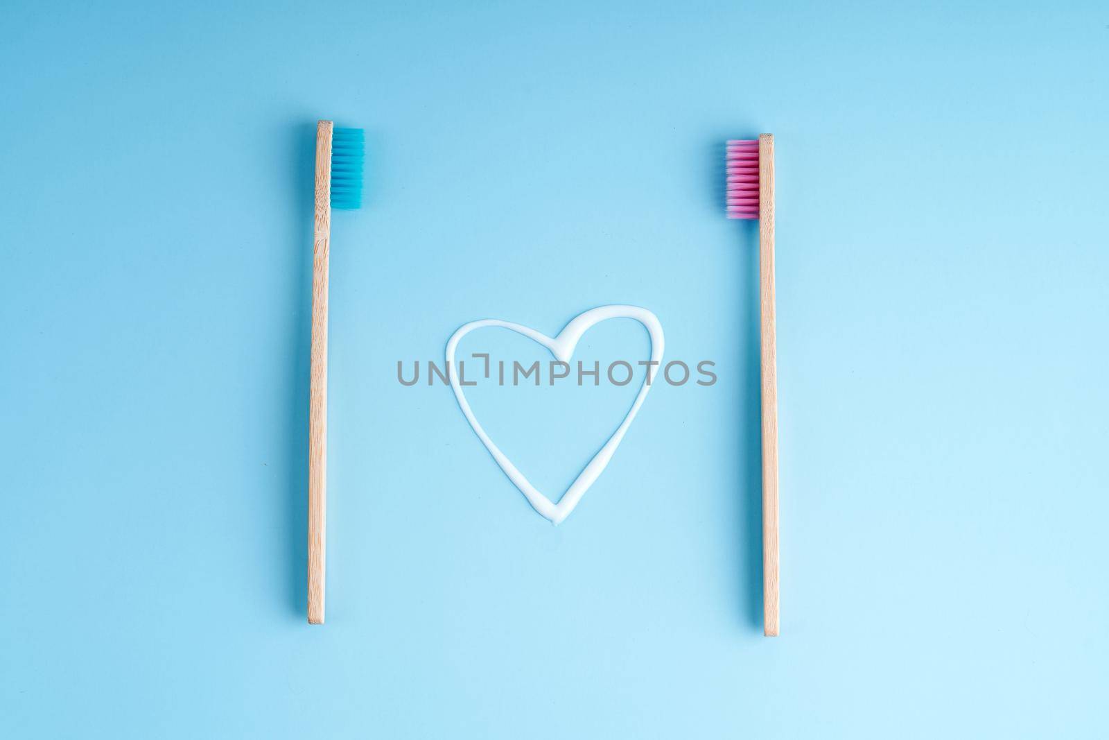 A pair of eco-friendly bamboo toothbrushes. Global environmental trends. Toothbrushes of different genders by Try_my_best