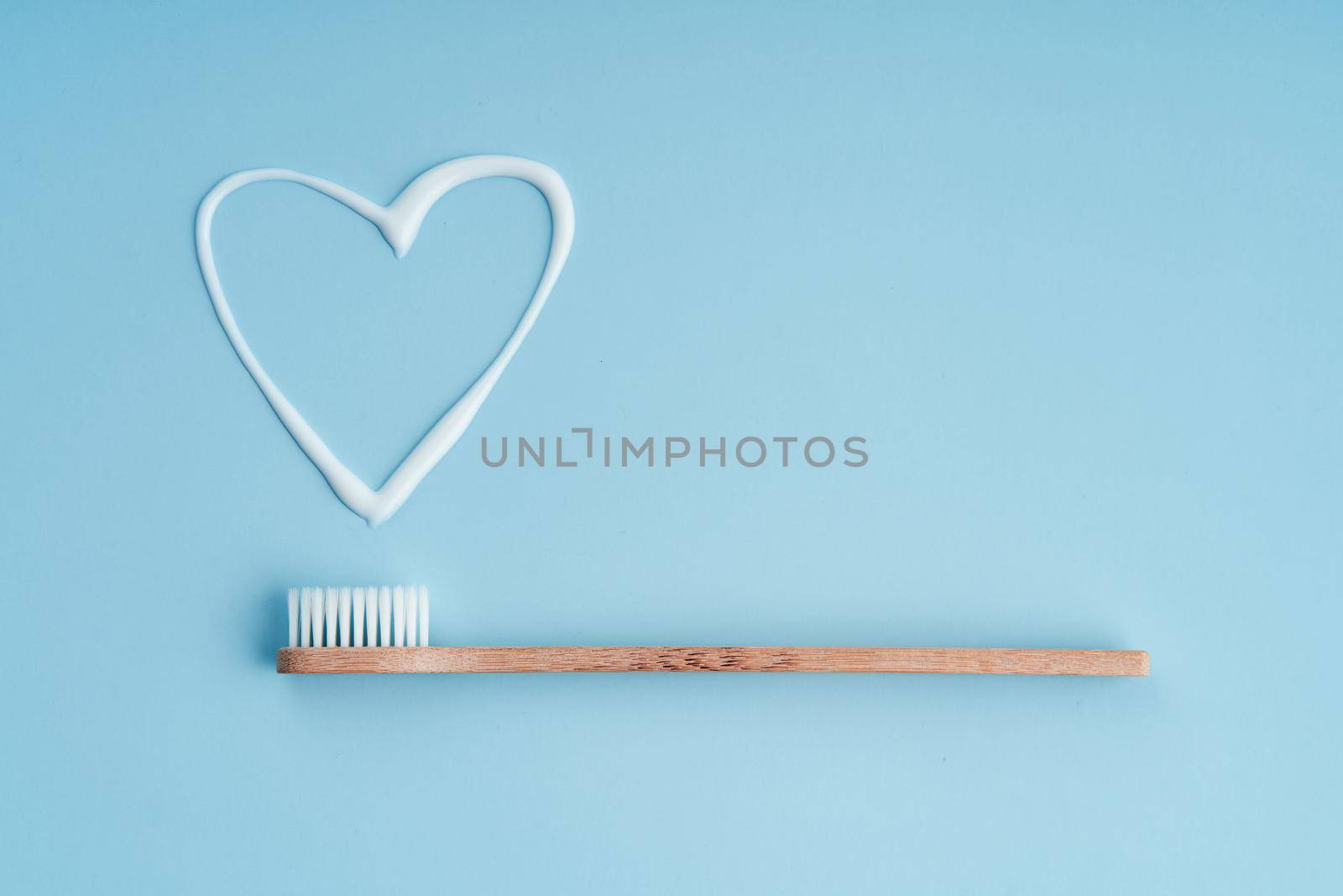 Eco-friendly trendy bamboo toothbrush. Popular toothbrushes. Hygiene trends. Top view with toothpaste by Try_my_best