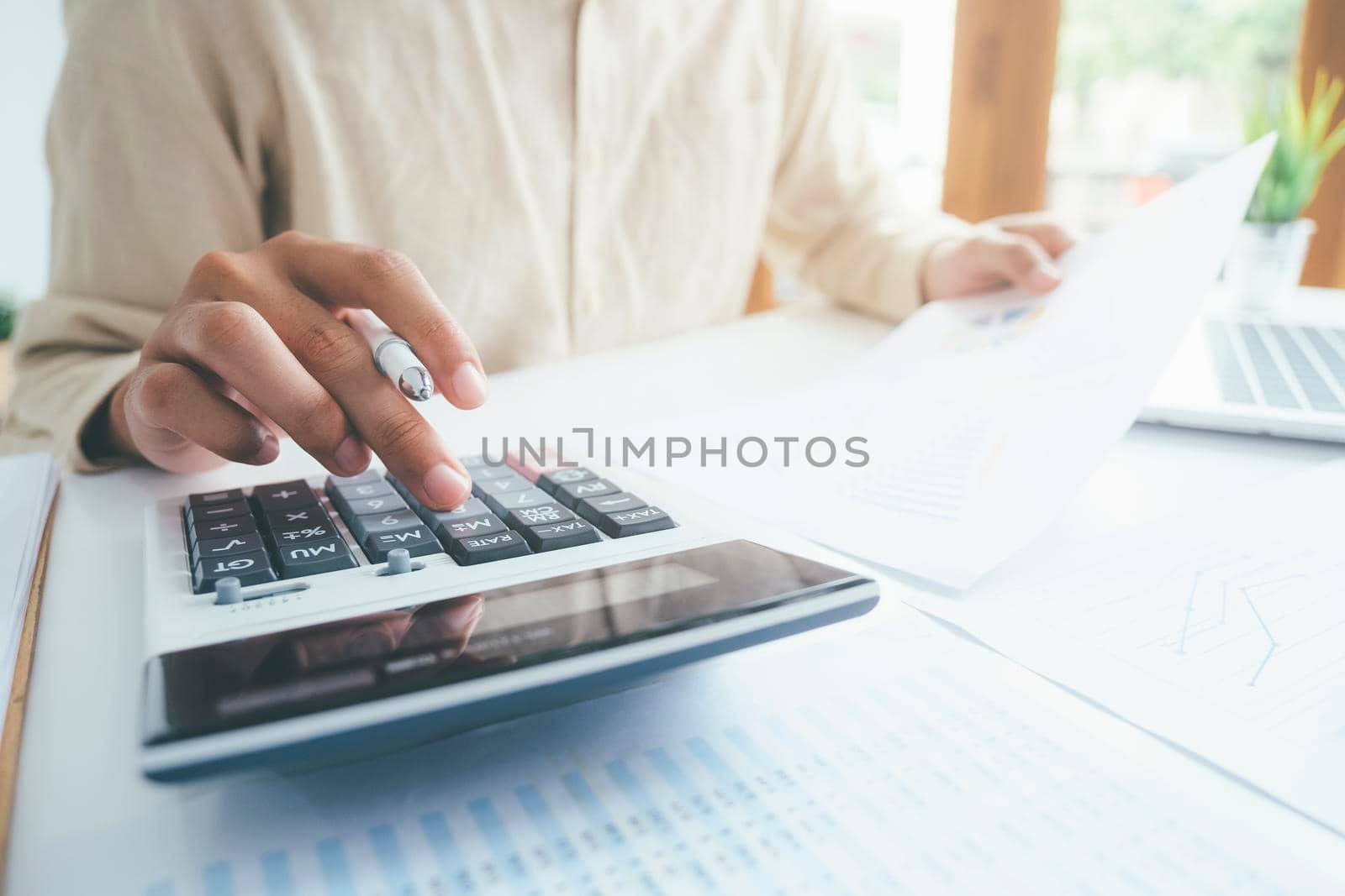 Male accountant or banker use calculator.