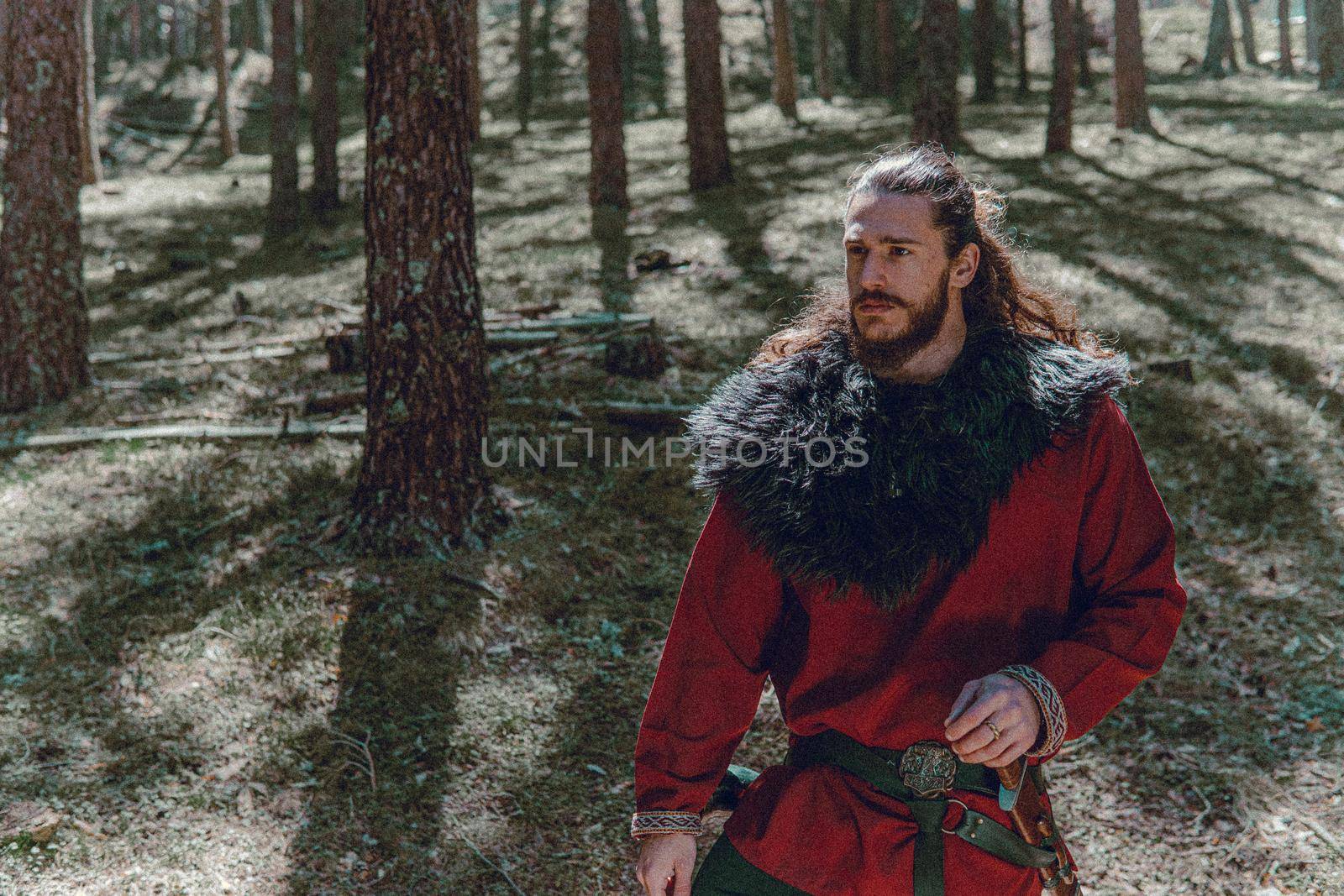 Viking with an angry look on his face in a Norwegian forest.