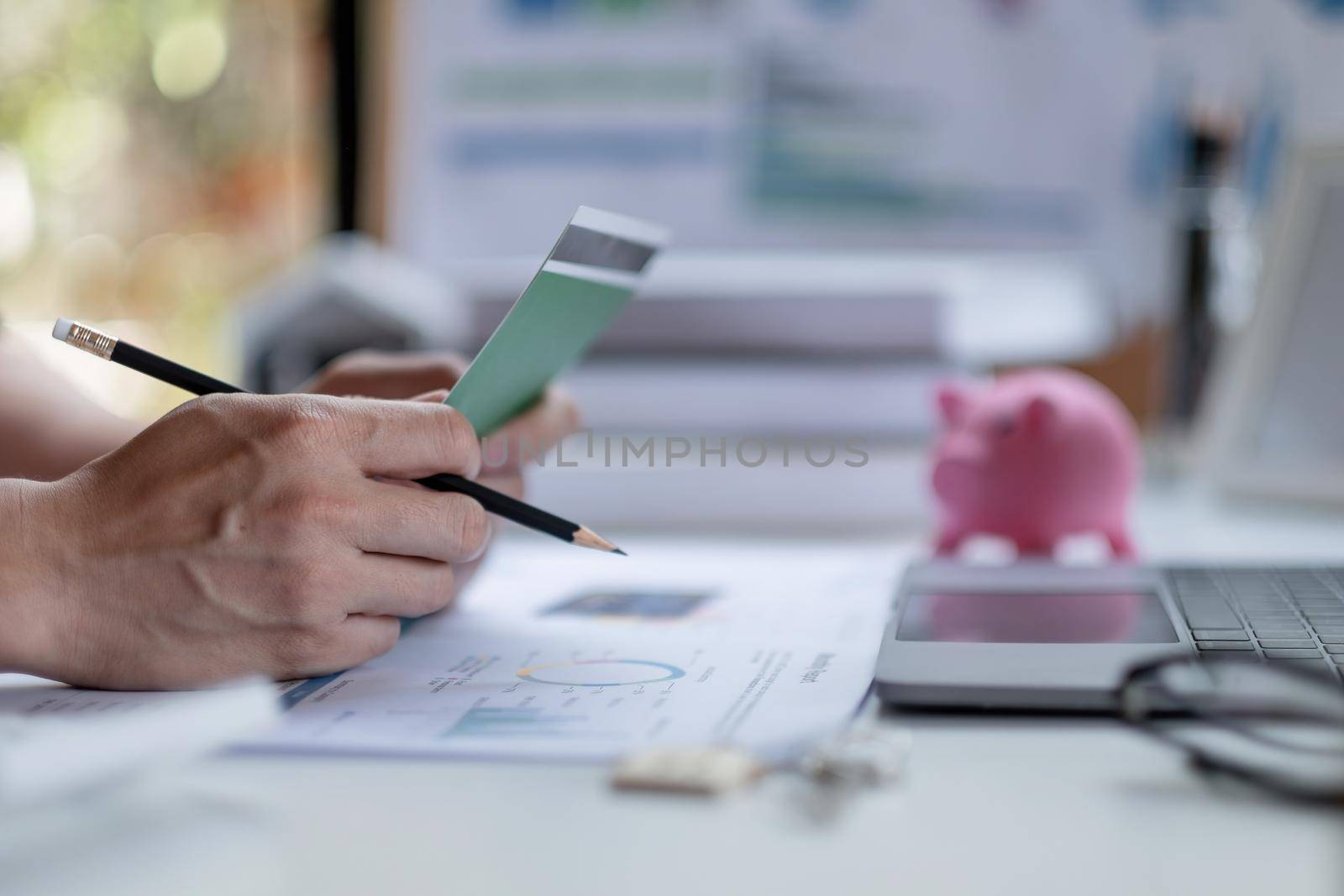 Business man hands holding saving account passbook with calculator, account and saving concept.