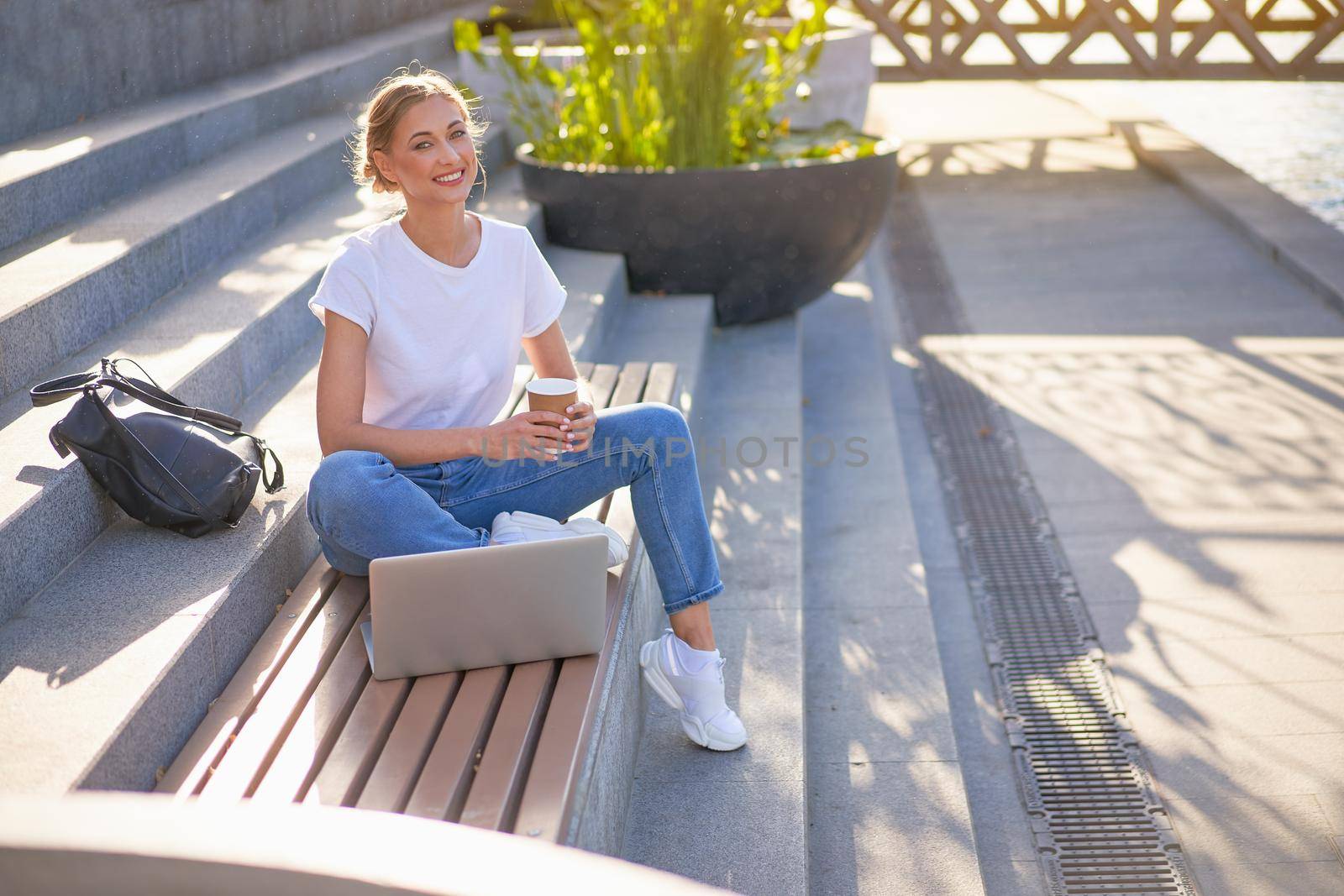 Businesswoman sitting stairs summer park using laptop Business persone working remote. Outdoor Successful european caucasian woman freelancer make video call teacher study work online lessons