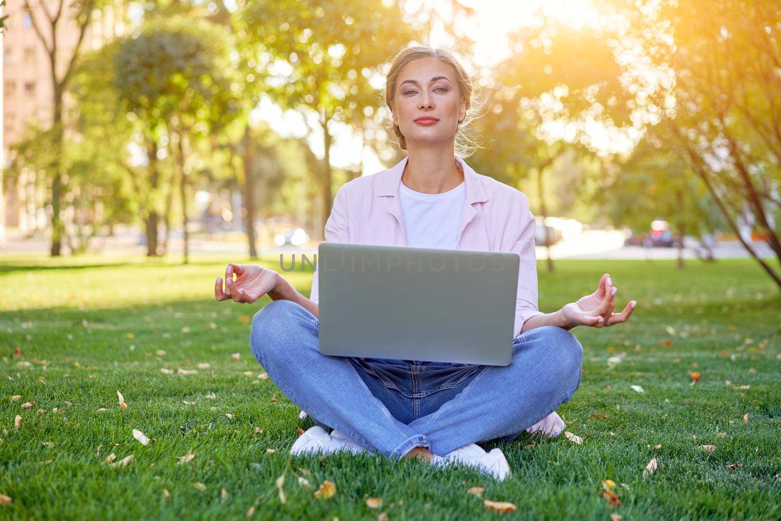 Businesswoman sitting grass summer park using laptop Business person working remote. Outdoor Successful european caucasian woman freelancer make video call teacher study work online lessons