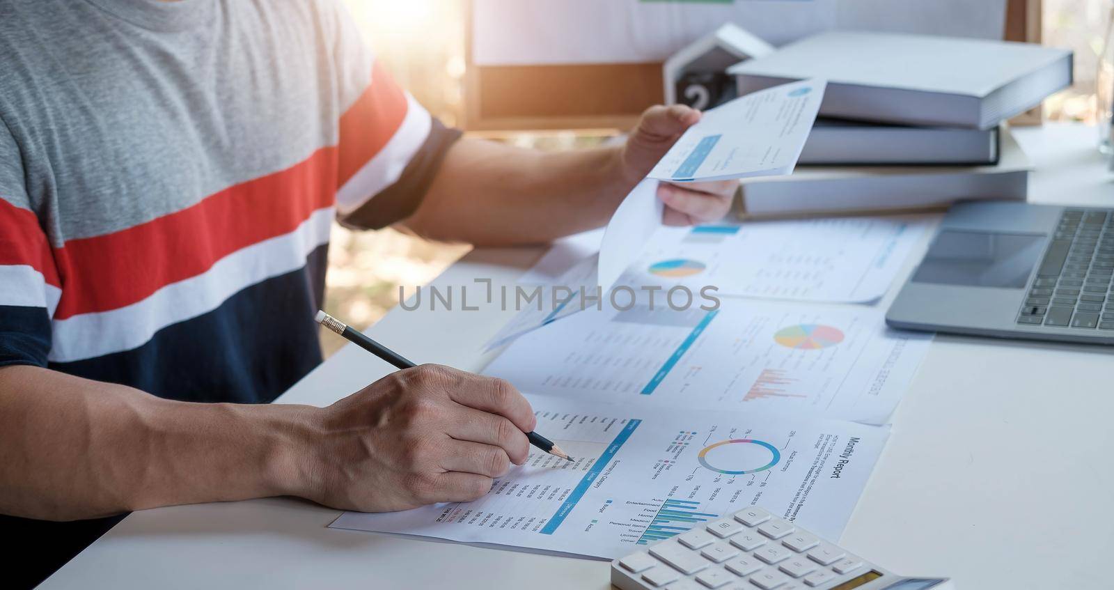 A man using calculator for calculate expenses bills in his workplace. Business concept..