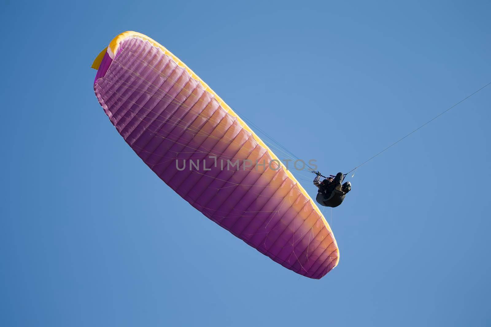 Belarus city Gomel October 7, 2018. Performances on paragliding.A paraglider flies in the sky under a multi-colored paraglider.Man under parachute