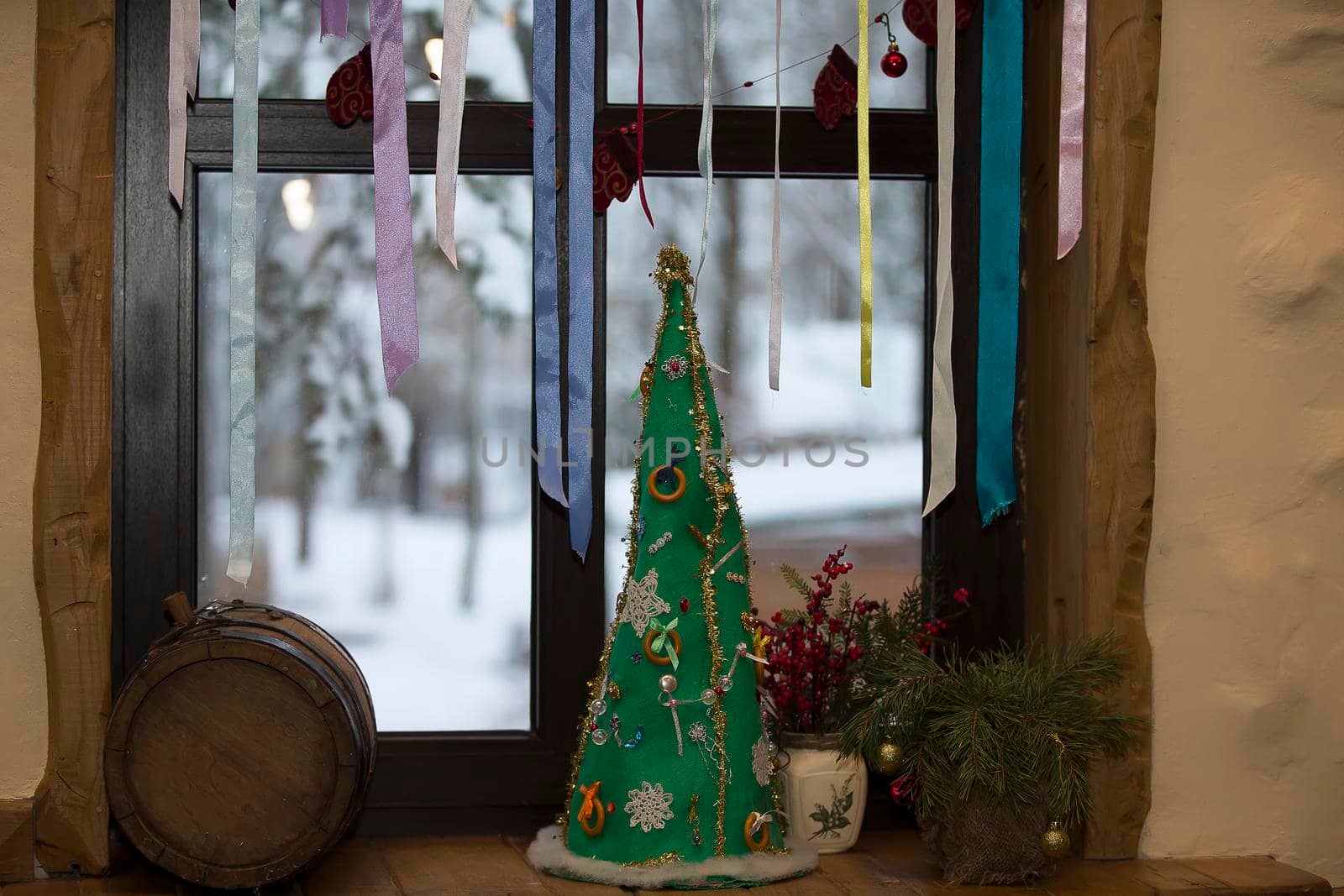 New Year's still-life. Christmas tree handmade Ukrainian tapes. Dress up the tree with a bagel. Christmas decorated window
