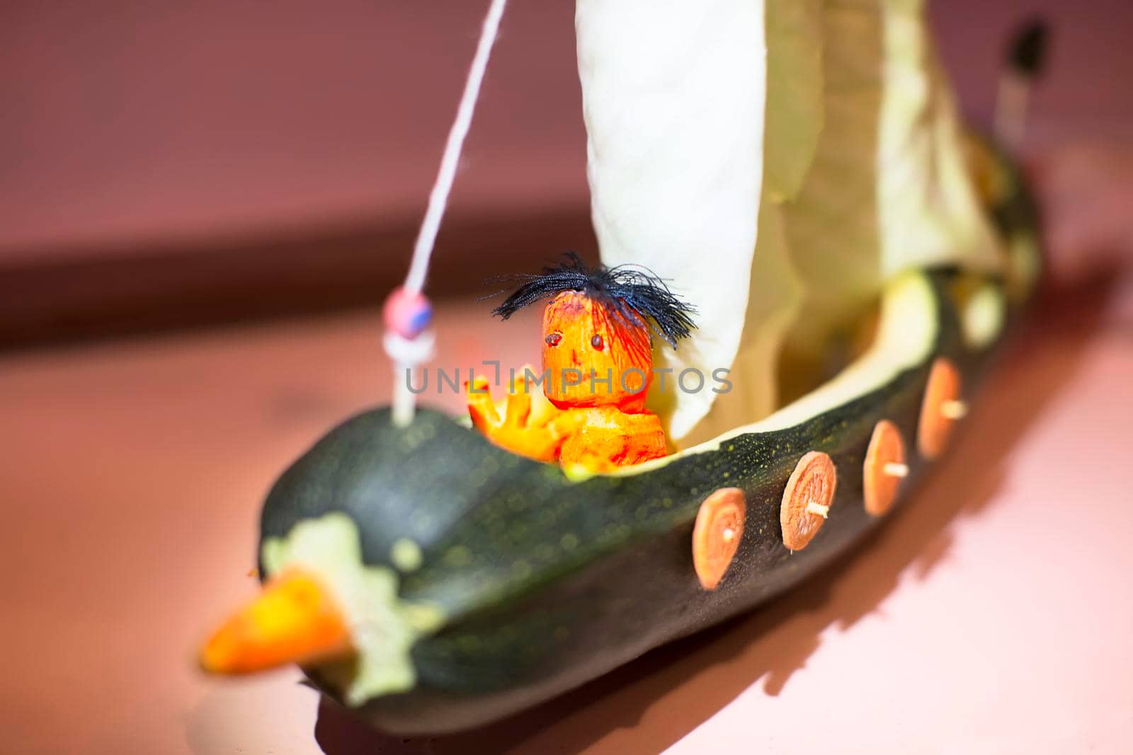 A ship and a sailor made of squash and carrots
