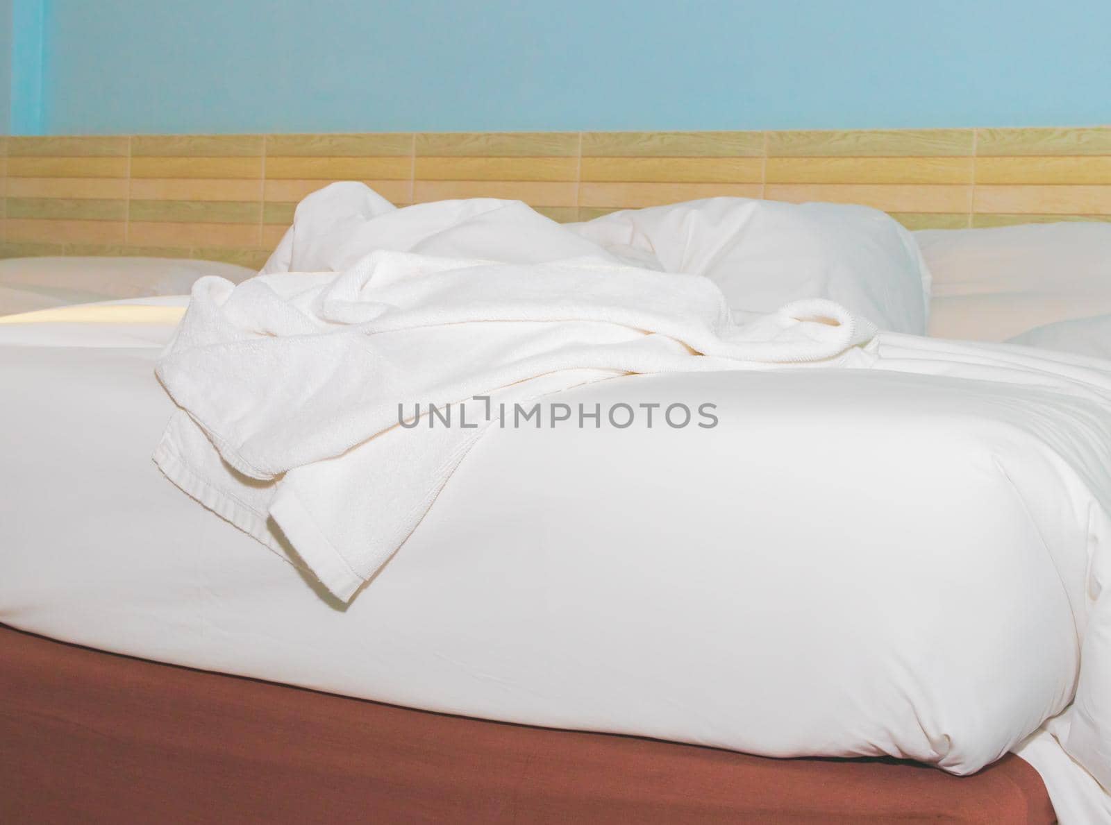 bed and  bedspread pillow white in in bedroom by pramot
