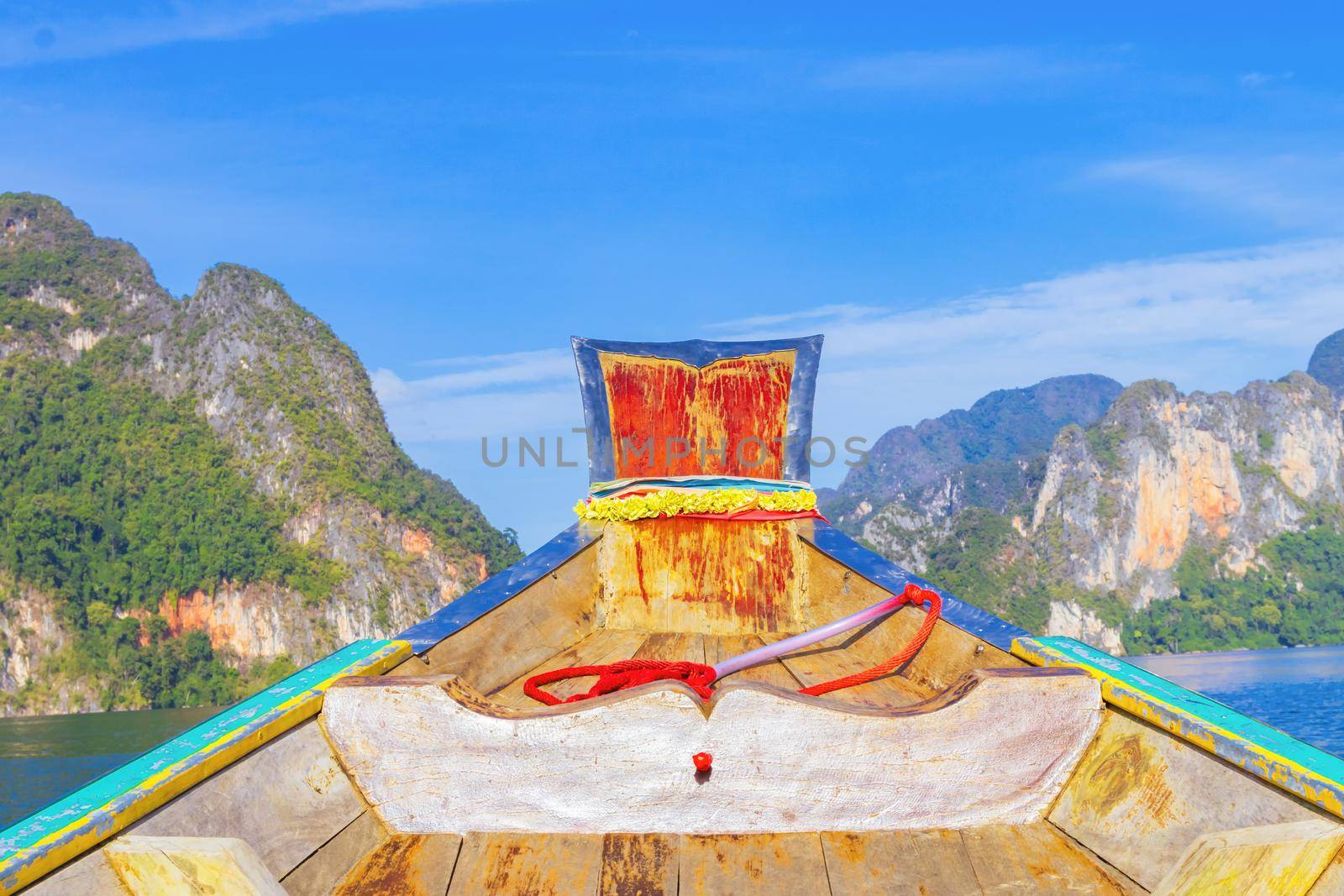 Wooden boat on sailing travel in Ratchaprapa Dam and Cheow Larn Lake, Khao Sok nature beautiful in Thailand by pramot