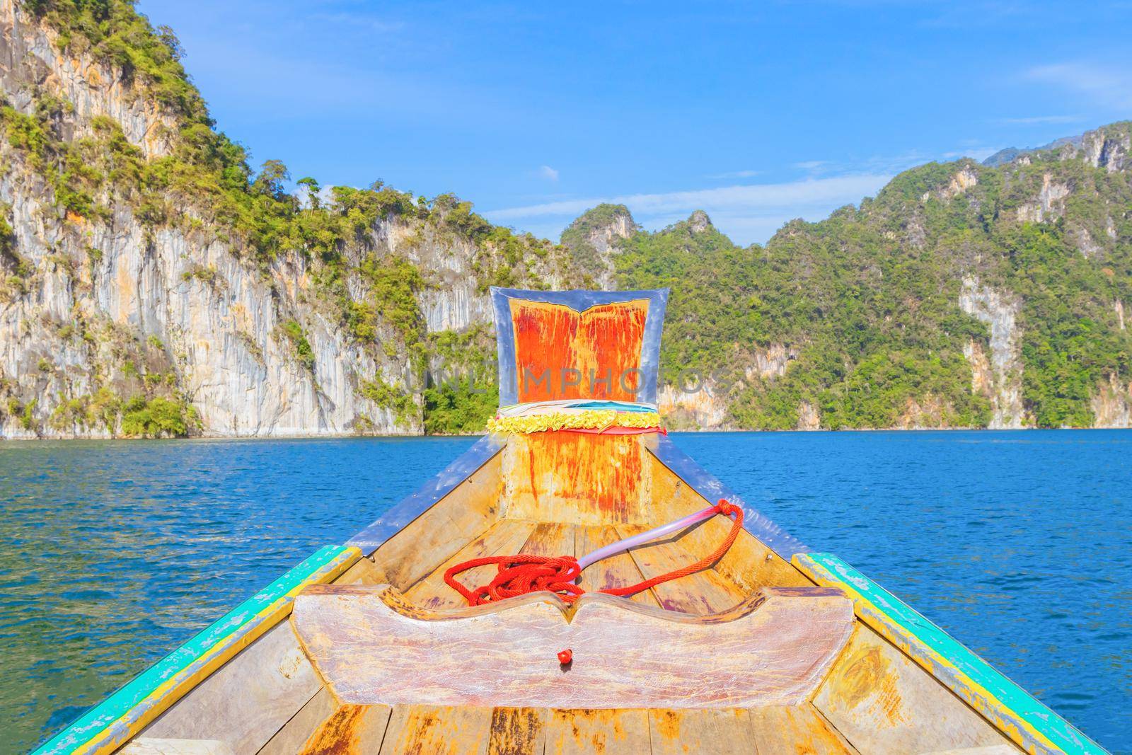 Wooden boat on sailing travel in Ratchaprapa Dam and Cheow Larn Lake, Khao Sok nature beautiful in Thailand by pramot