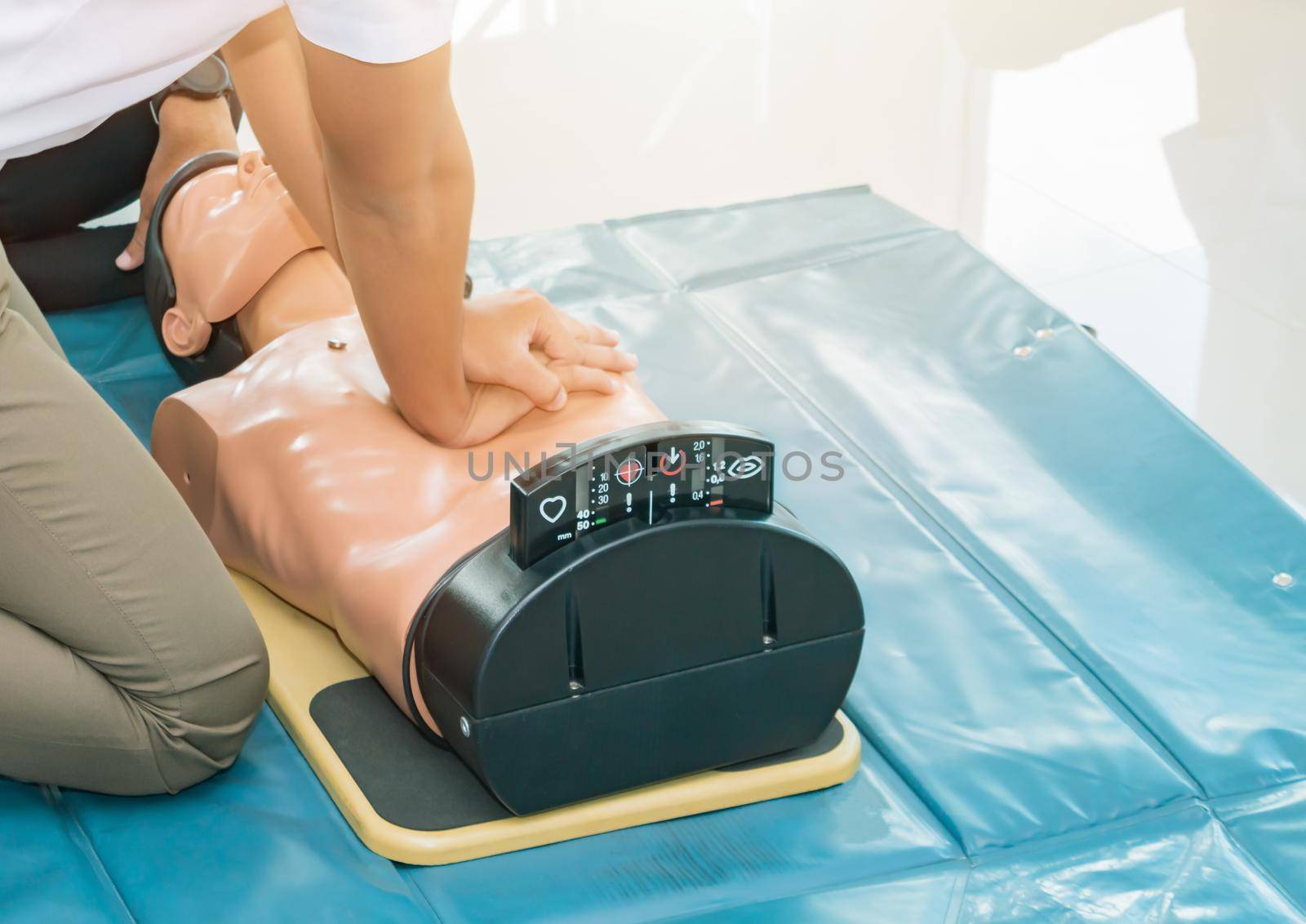 CPR aid dummy medical training with hand press Heart on doll emergency refresher training Concept closed-up. by pramot