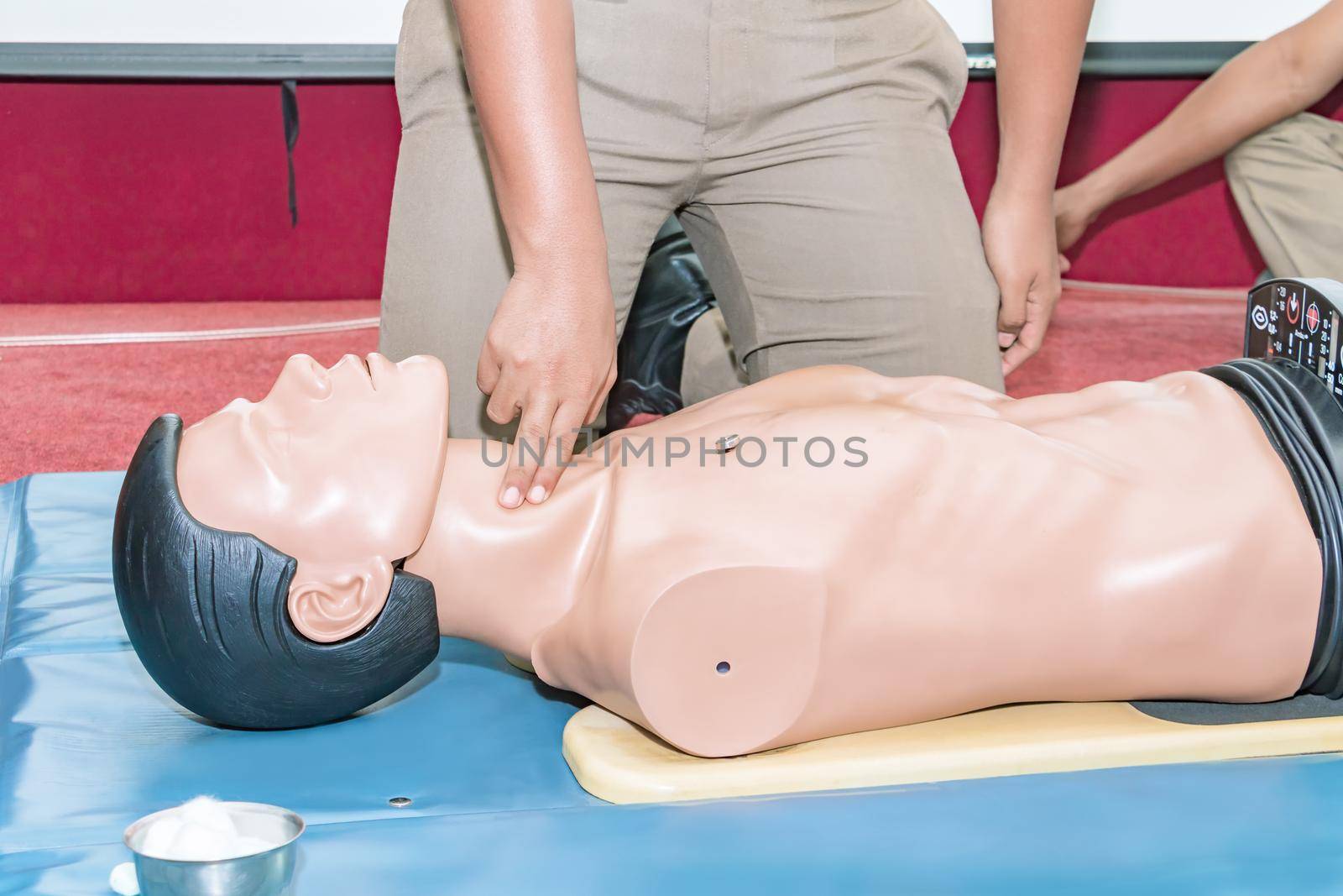 CPR aid dummy medical training with hand press Heart on doll emergency refresher training Concept closed-up. by pramot