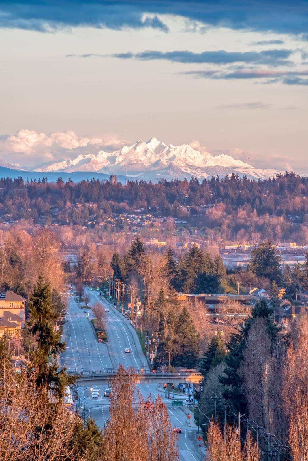 Empty city street in sunset light with mountain Baker on the background.