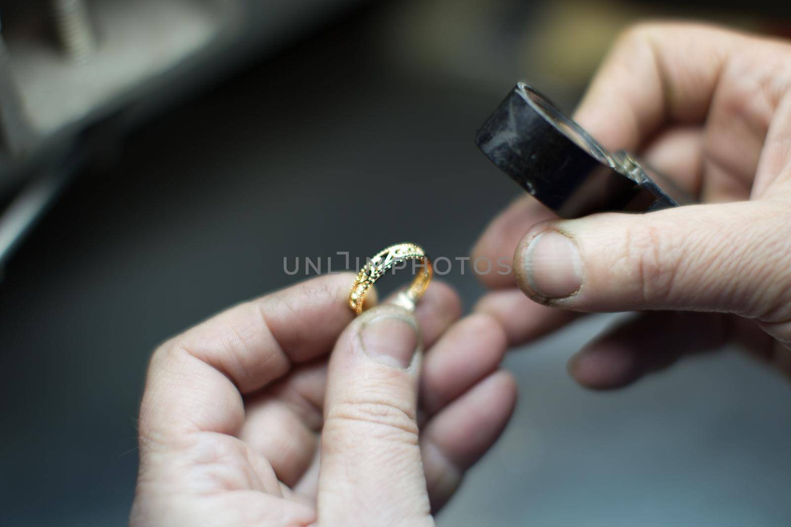Industrial manufacture of the gold ring.Working hands make a gold decoration
