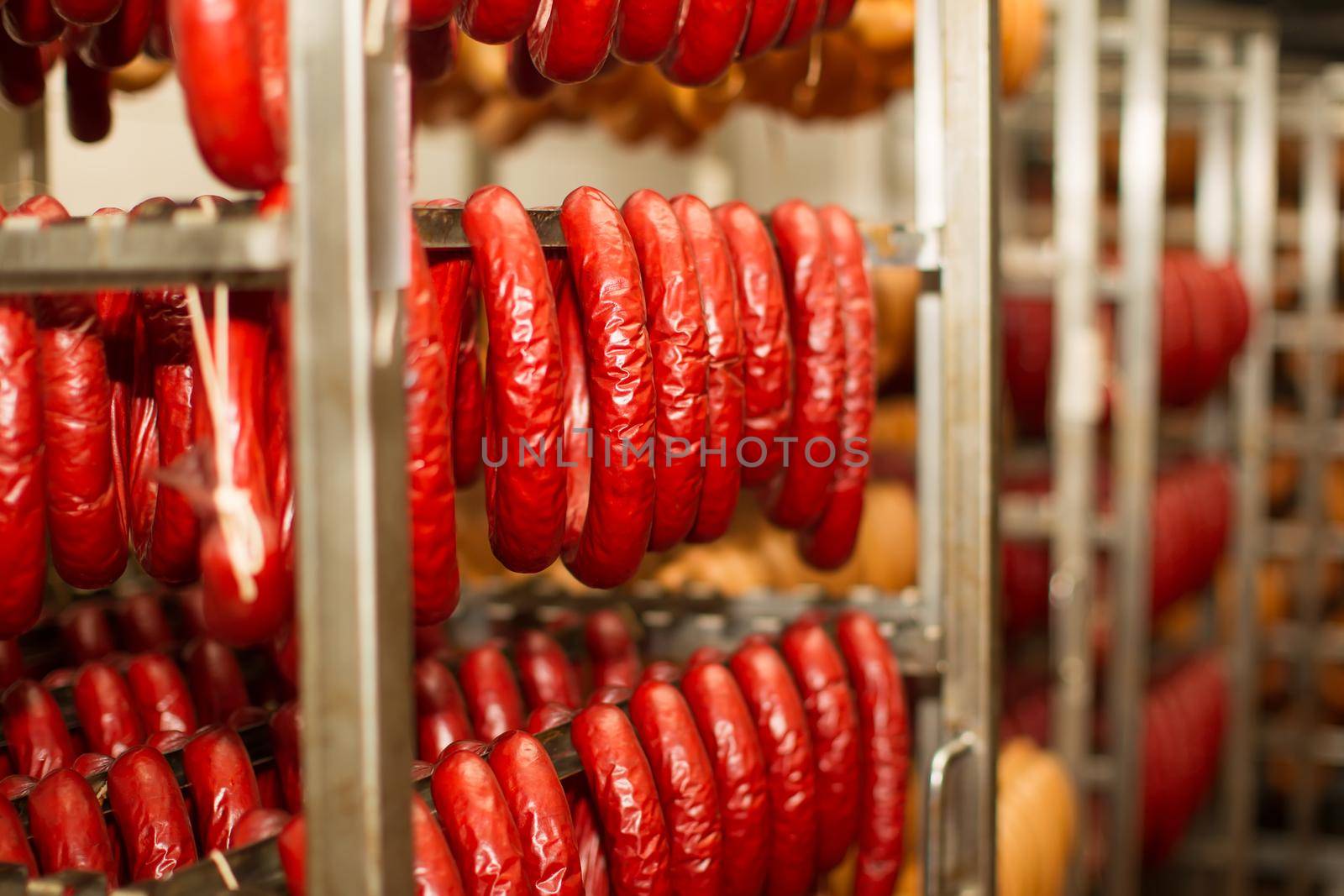 Sausage workshop.stick of sausage are smoked on the background of the meat factory