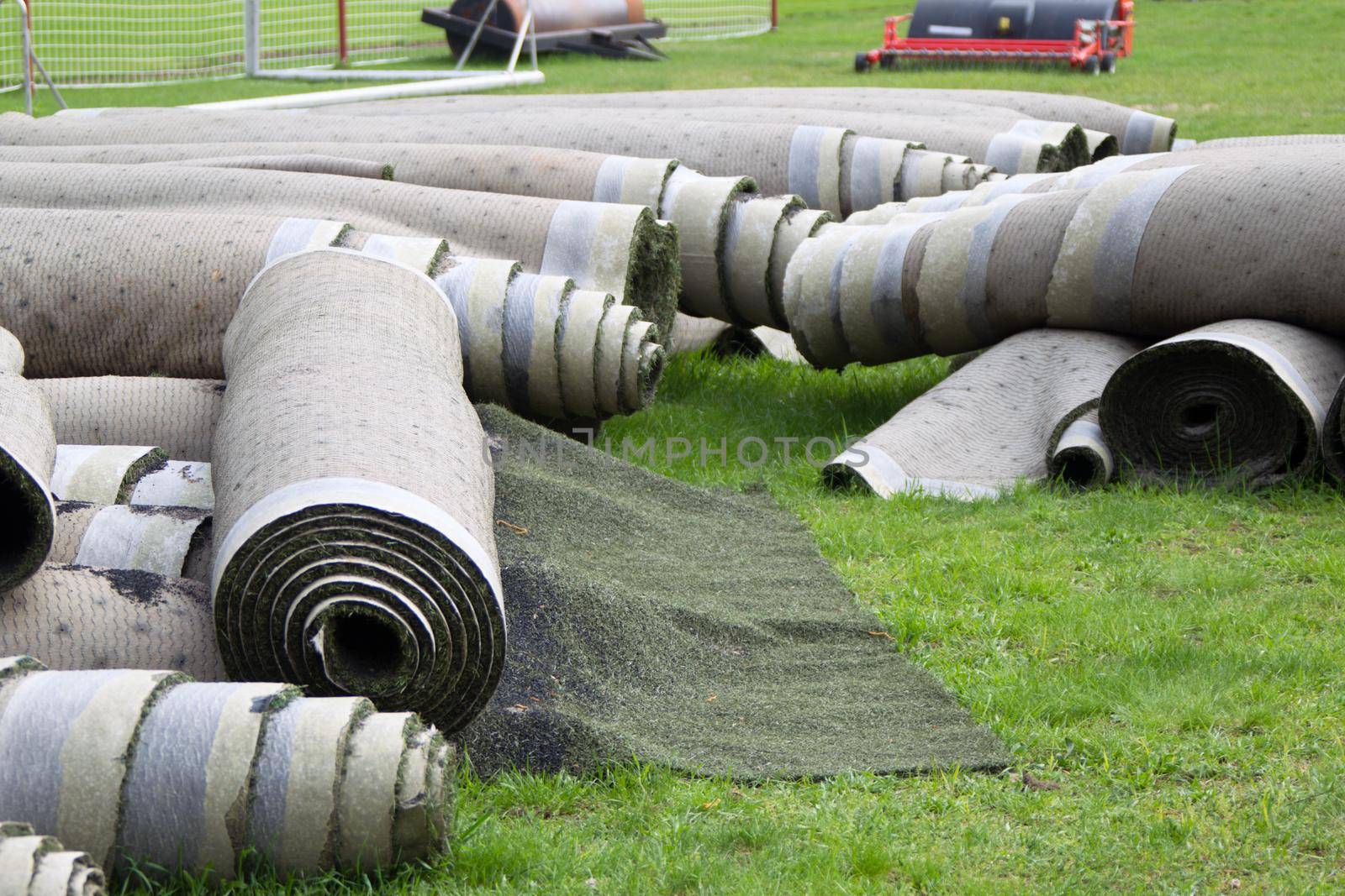 Old artificial lawn twisted into rolls
