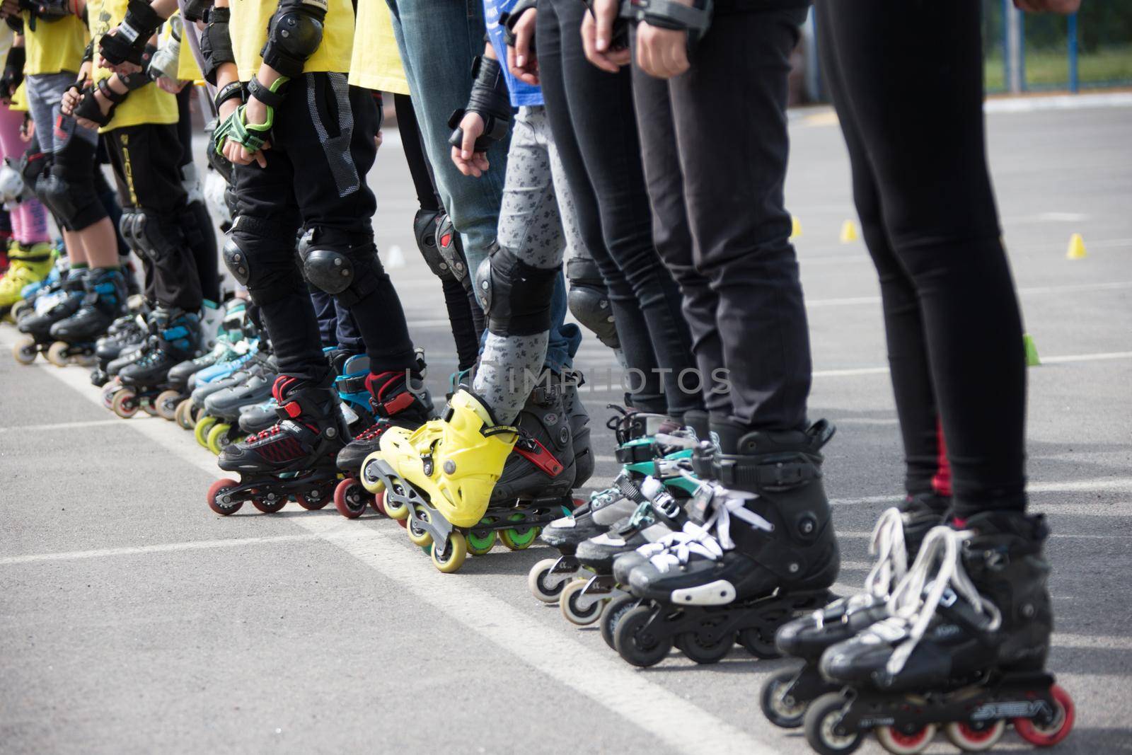 Close up view of wheels befor skating.Legs in rollskikovye skates are lined up in a row