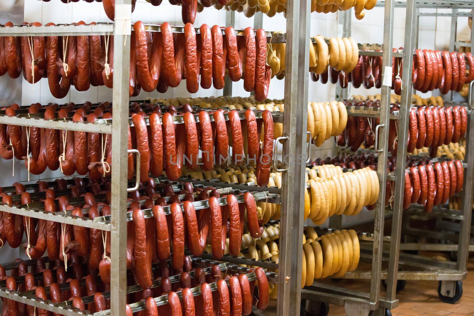 Sausage workshop.stick of sausage are smoked on the background of the meat factory