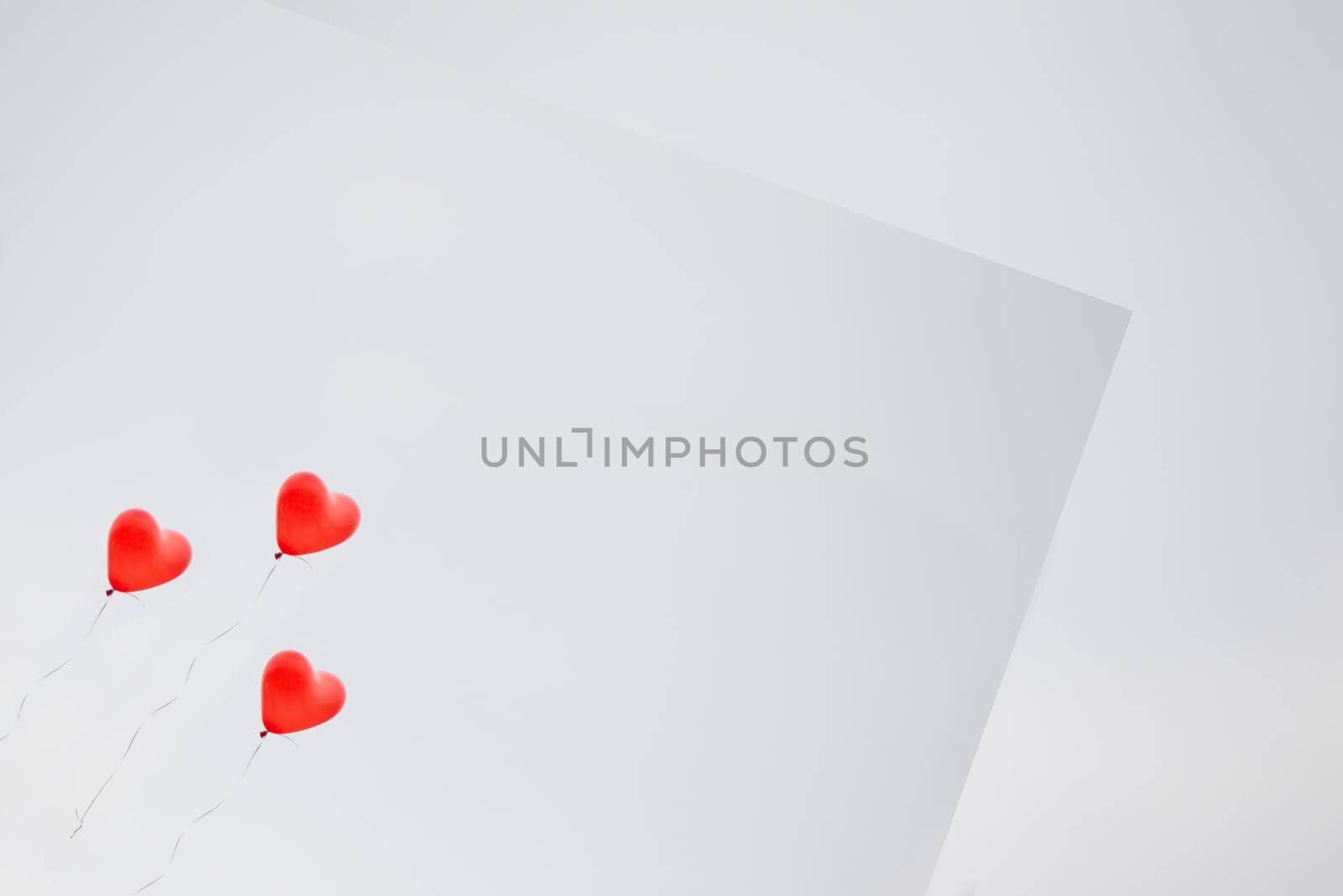 Gray background greeting card with red inflatable balls