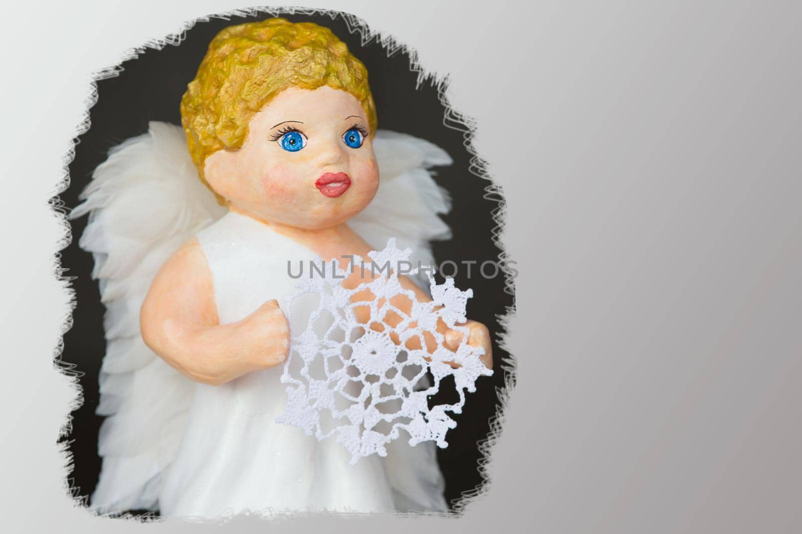 Doll angel with a knitted snowflake close-up