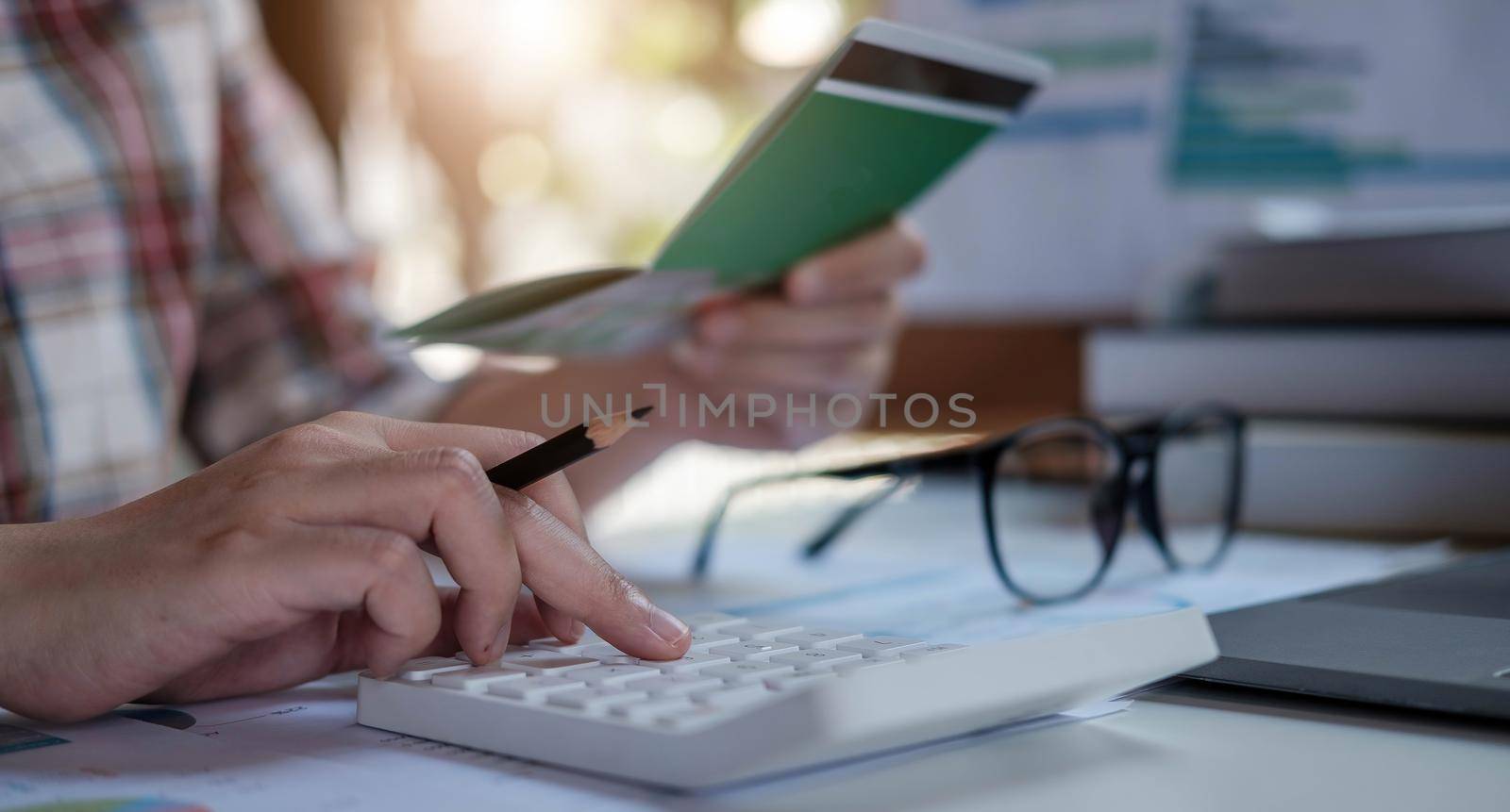 Young asian woman checking bills, taxes, bank account balance and calculating credit card expenses. Family expenses concept..