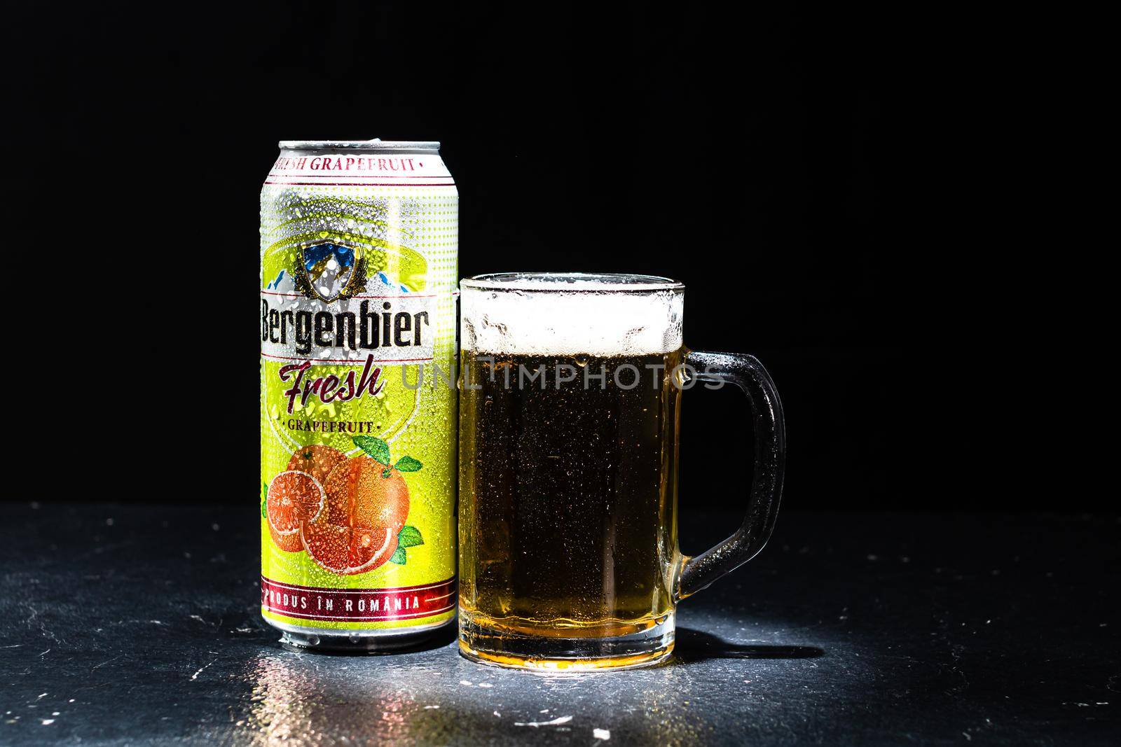 Can of Bergenbier beer and beer glass on dark background. Illustrative editorial photo shot in Bucharest, Romania, 2021 by vladispas