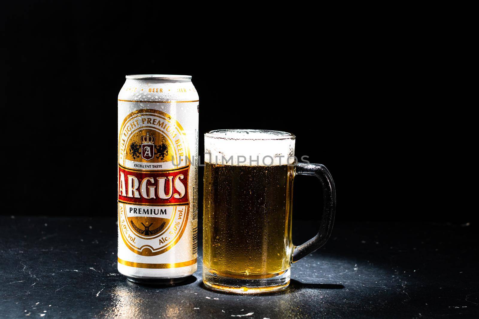 Can of Argus beer and beer glass on dark background. Illustrative editorial photo shot in Bucharest, Romania, 2021 by vladispas