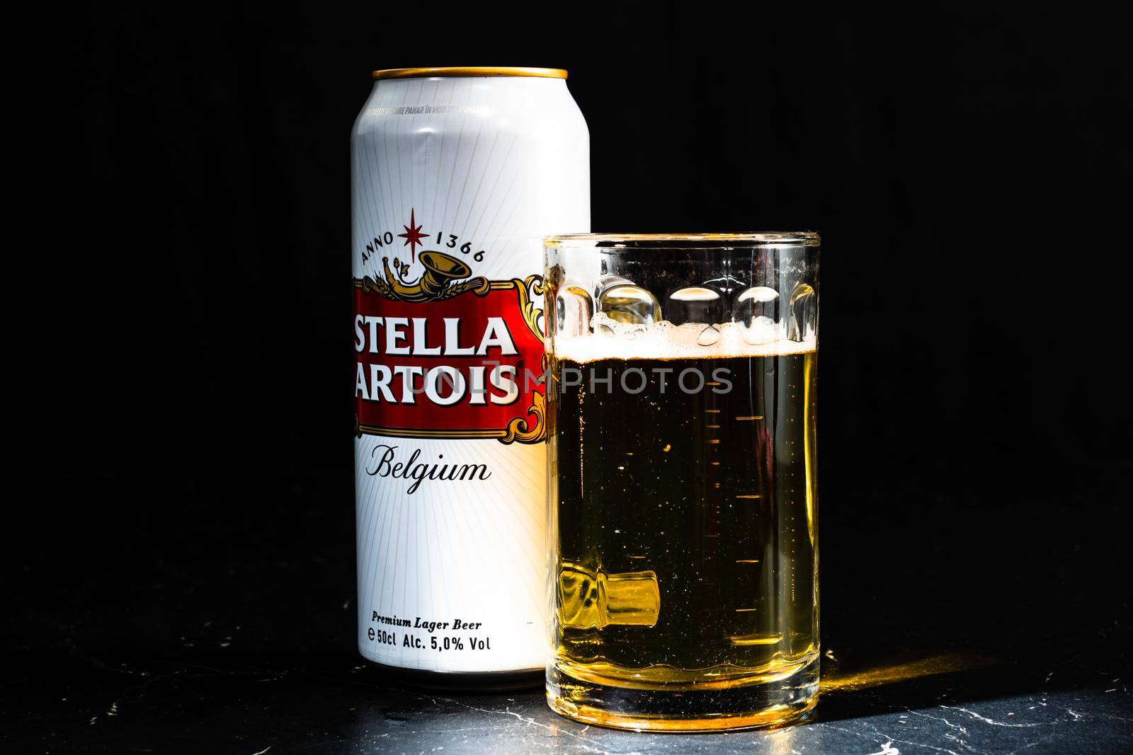 Can of Stella Artois beer and beer glass on dark background. Illustrative editorial photo shot in Bucharest, Romania, 2021 by vladispas