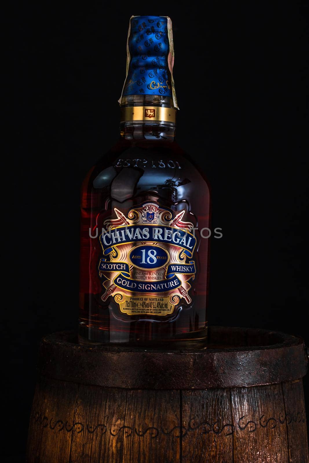 Chivas Regal 18 is blended from whiskies matured for at least 18 years. Whisky bottle on barrel. Illustrative editorial photo Bucharest, Romania, 2021 by vladispas
