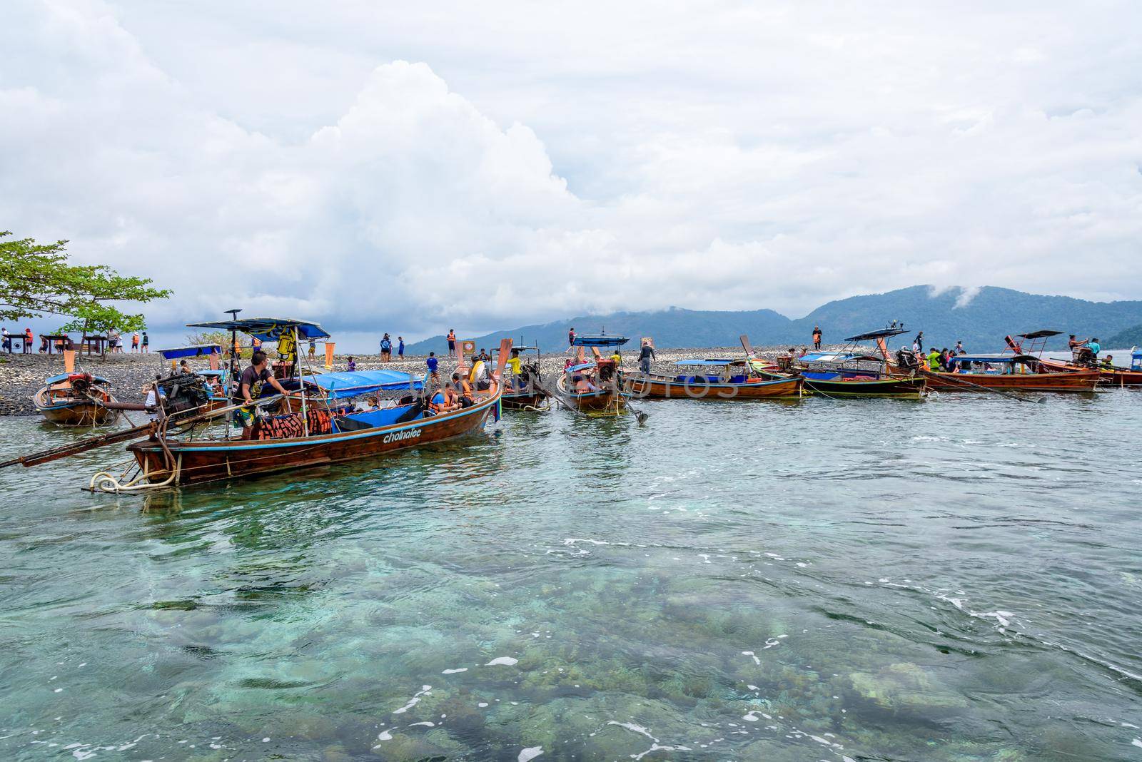 SATUN, THAILAND-APRIL 25, 2018: Tourist group travel by long tail boat arrive at Koh Hin Ngam island beautiful nature of the unusual rock with black color at Tarutao National Park in Thailand