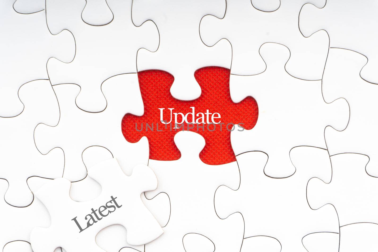 LATEST UPDATE text with jigsaw puzzle on red background. Business and Motivation Concept