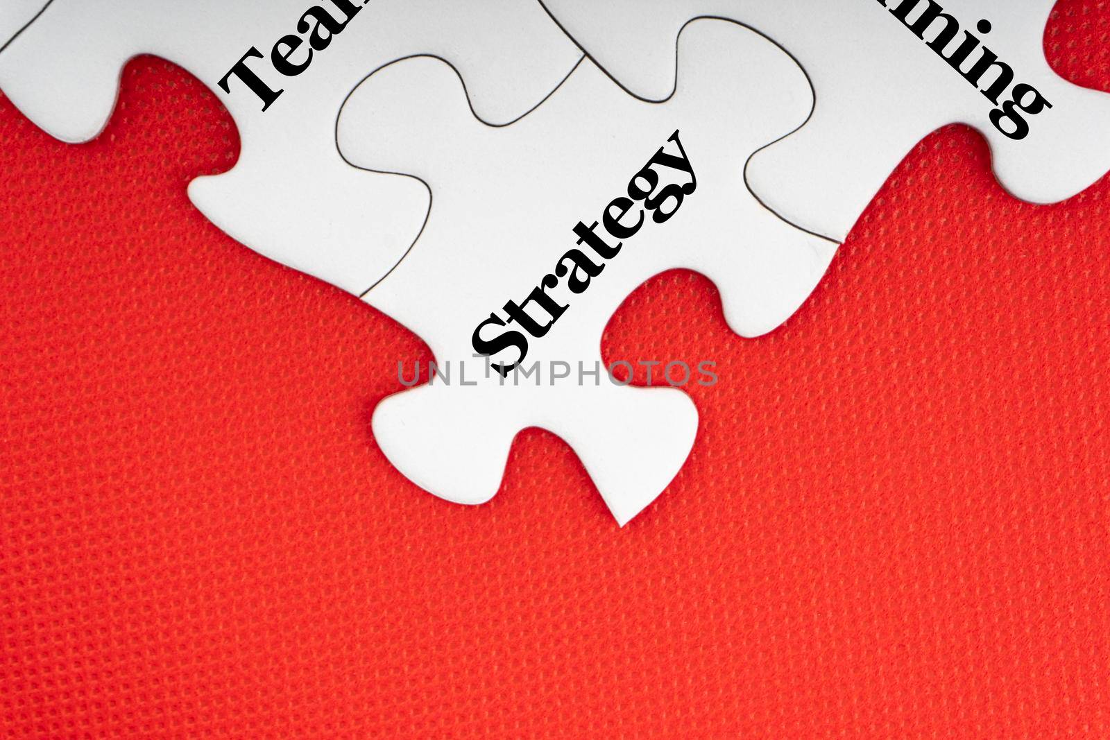 STRATEGY text with jigsaw puzzle on red background. by silverwings