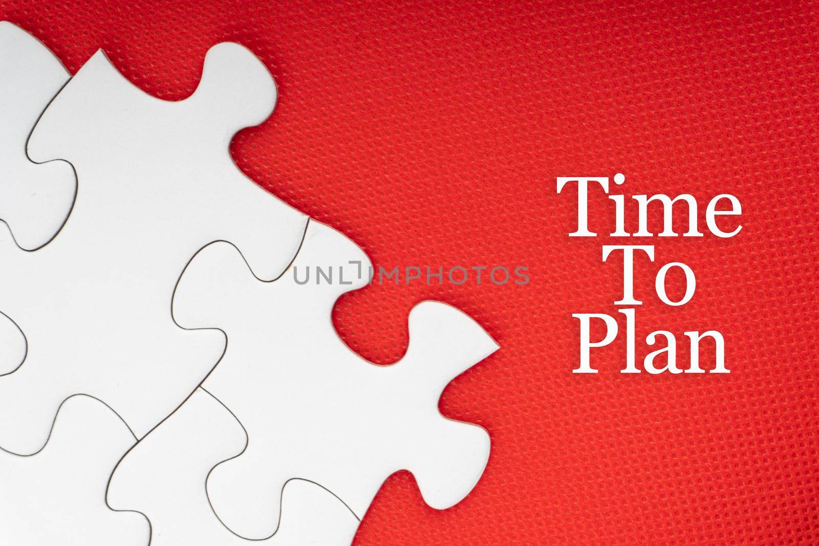 TIME TO PLAN text with jigsaw puzzle on red background.  by silverwings