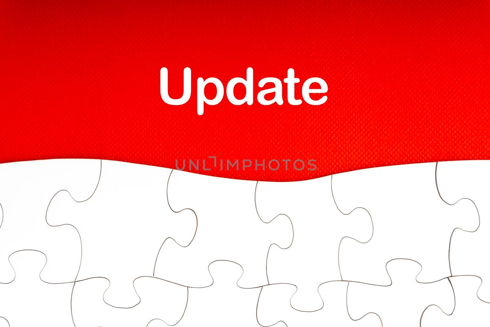 UPDATE text with jigsaw puzzle on red background. Business and Motivation Concept