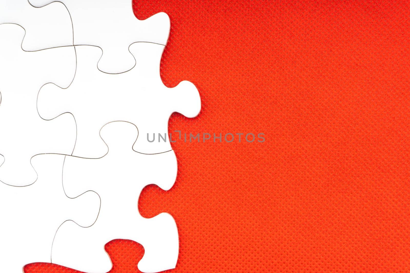 Jigsaw puzzle pieces on red background.  by silverwings