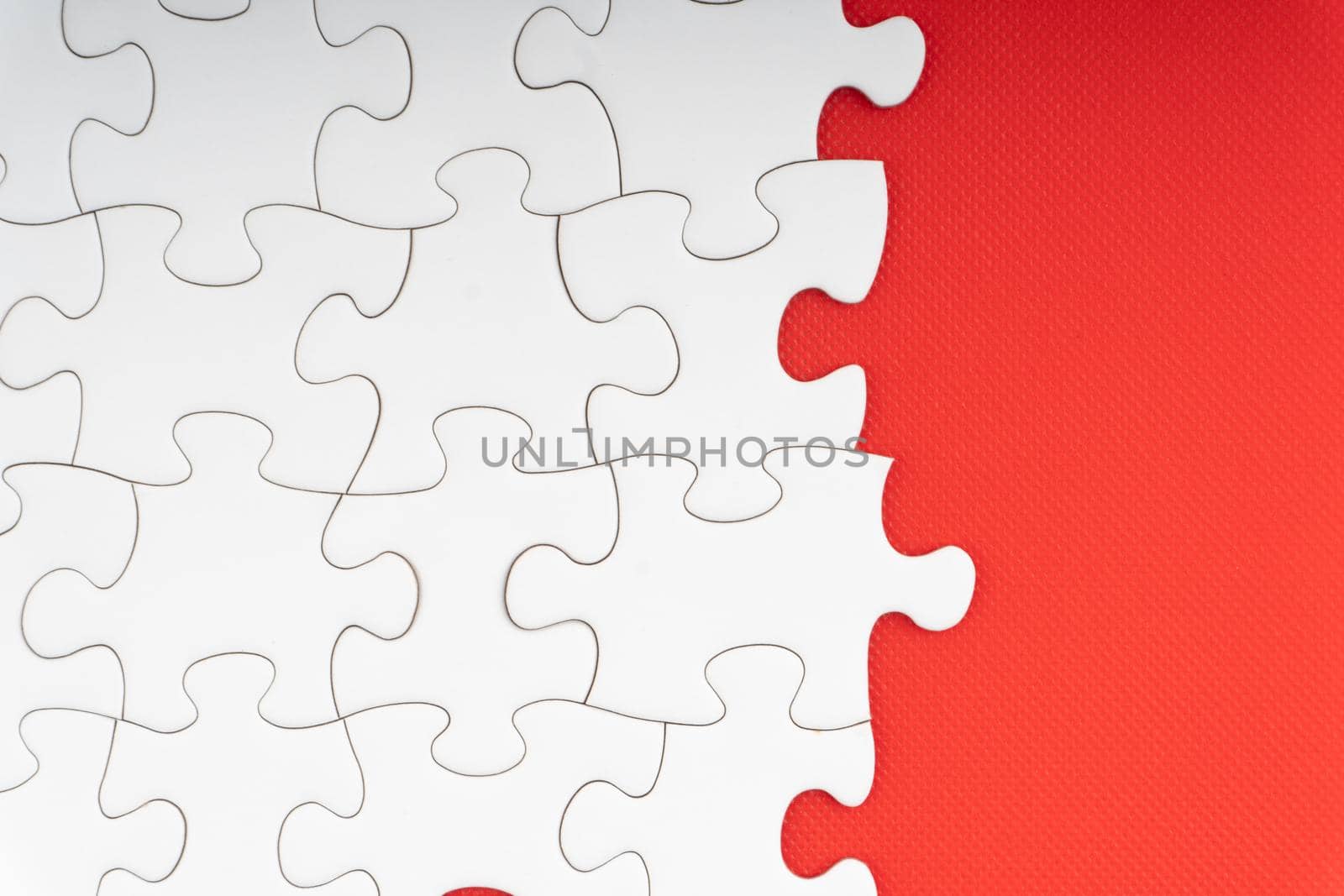 Jigsaw puzzle pieces on red background. Copy space and business concept