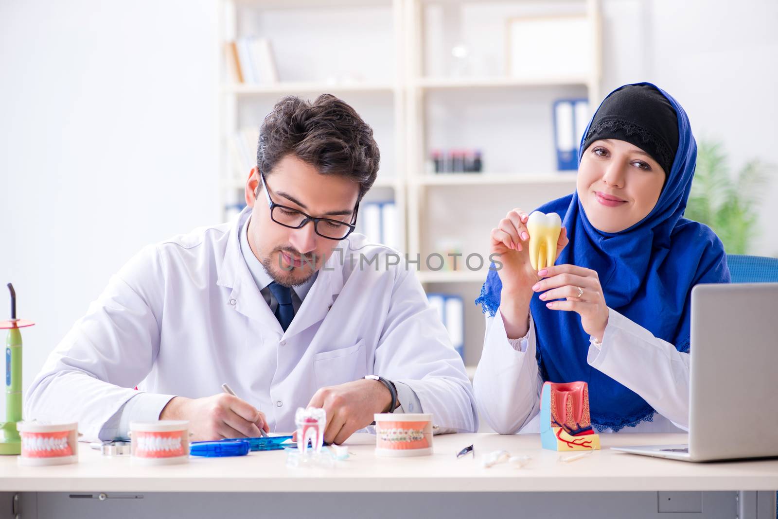 Dentist doctor and assistant working on new tooth implant