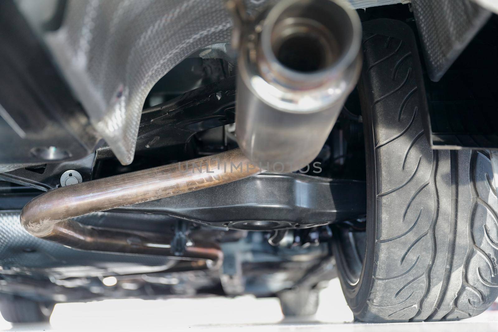 Car suspension and exhaust pipe