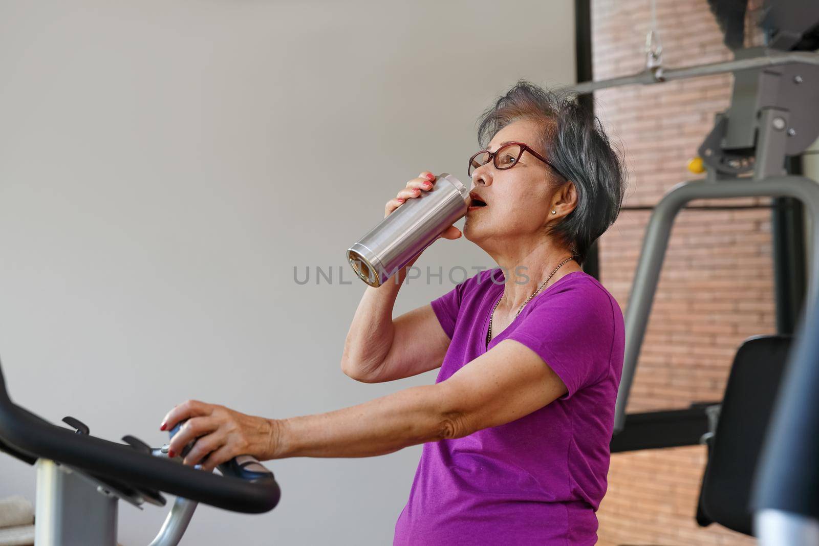 senior woman doing exercises in gym