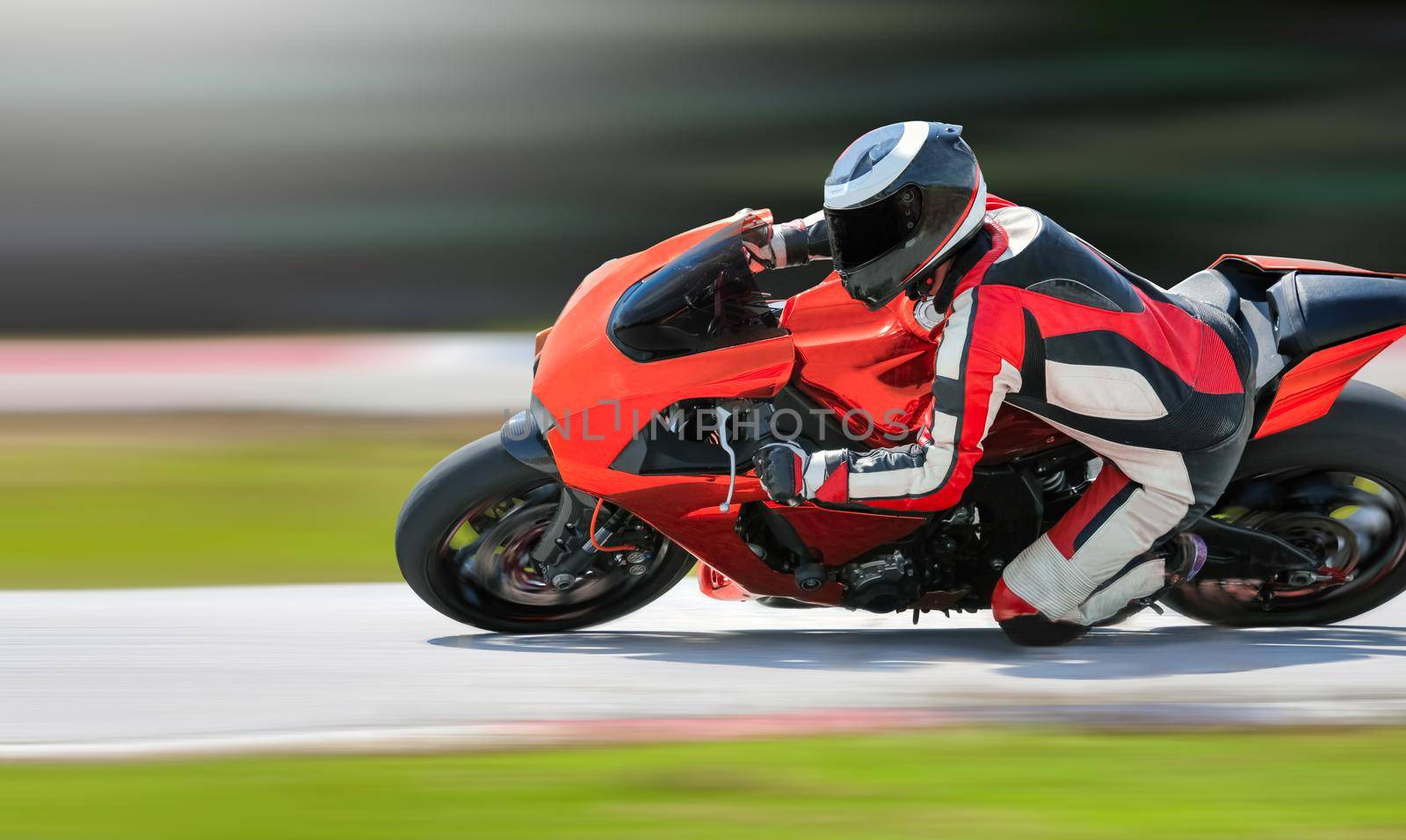 Motorcycle leaning into a fast corner on race track