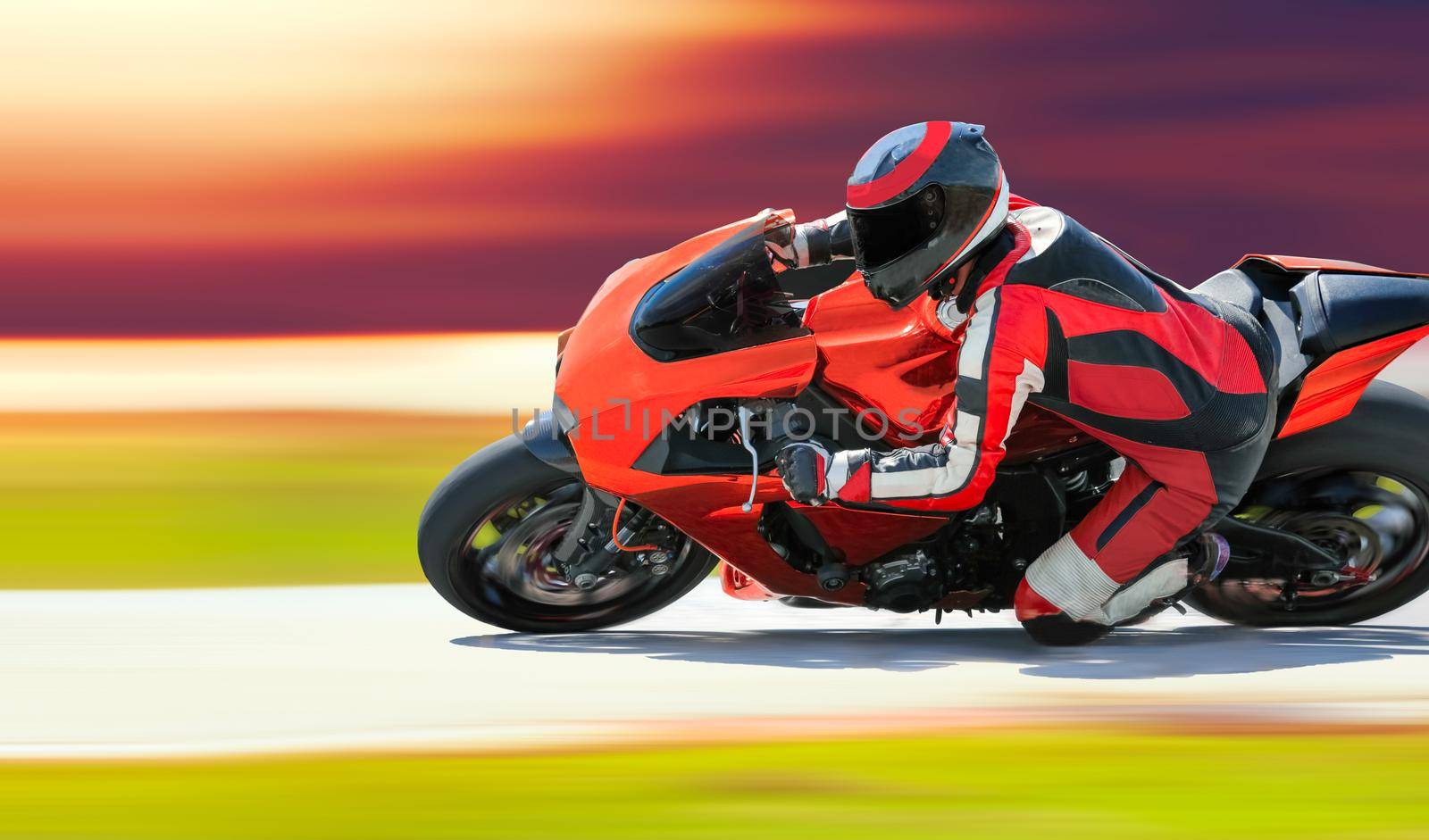 Motorcycle leaning into a fast corner on race track