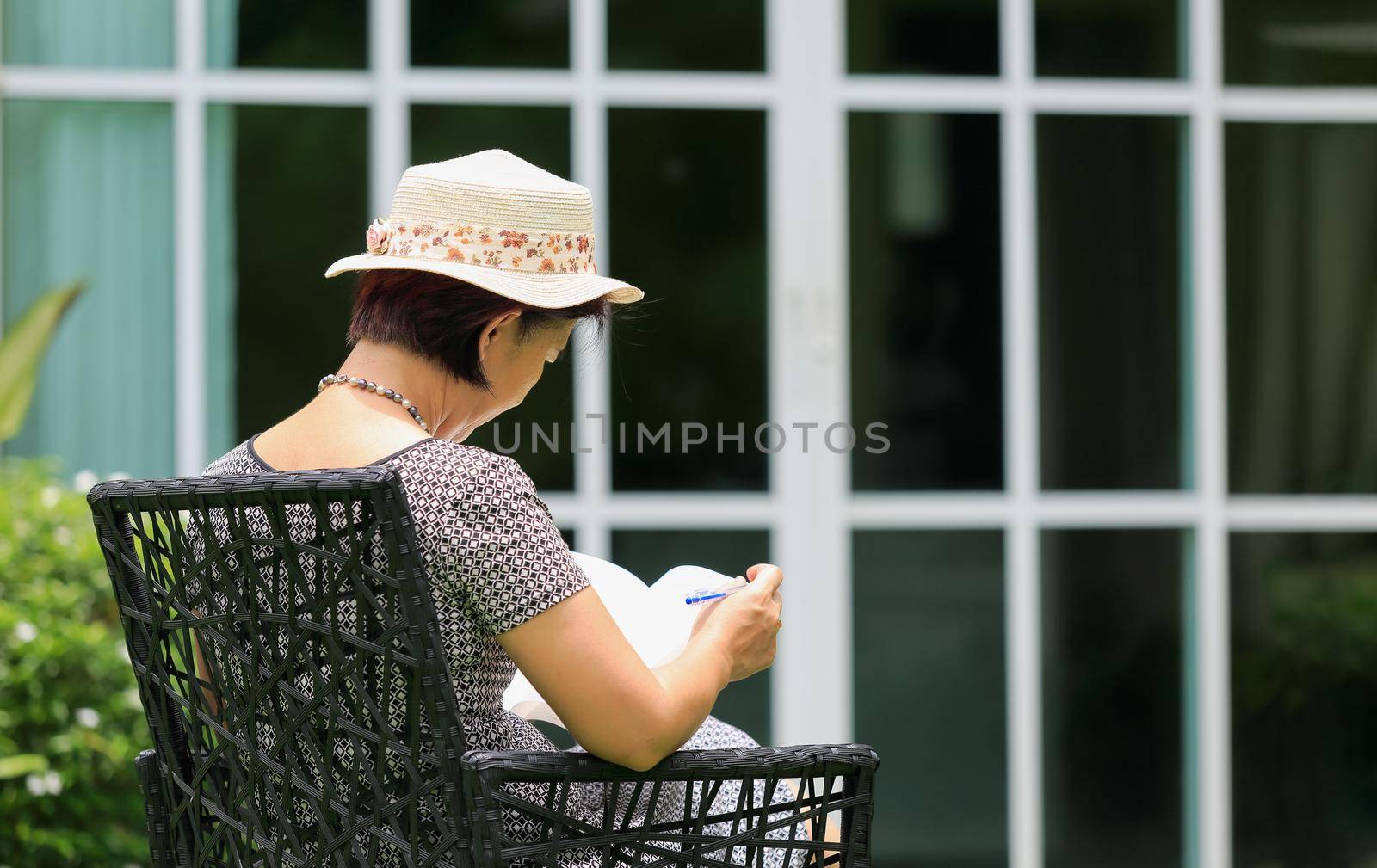 Asian middle aged female sitting relax in backyard by toa55