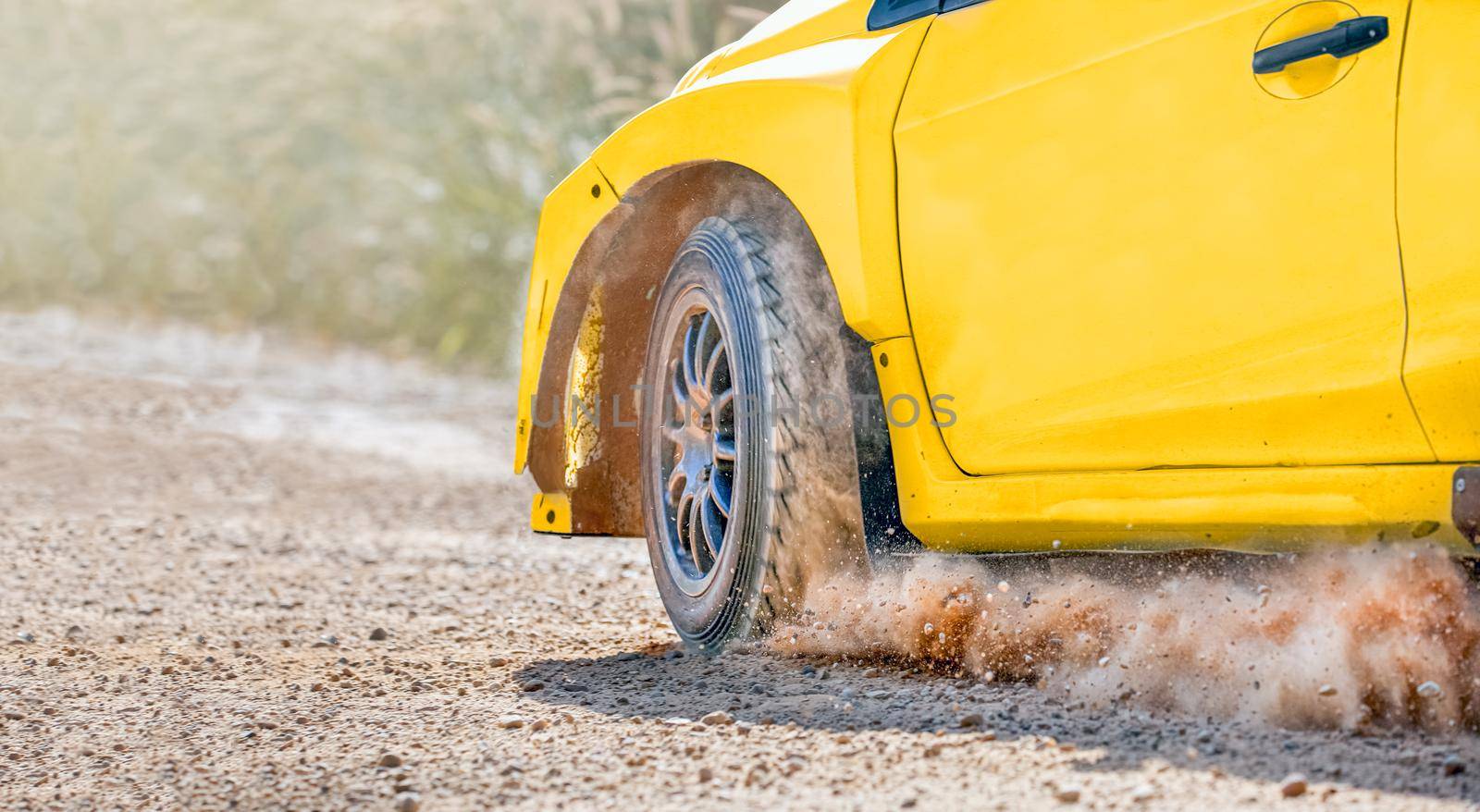 Rally racing car on dirt track.